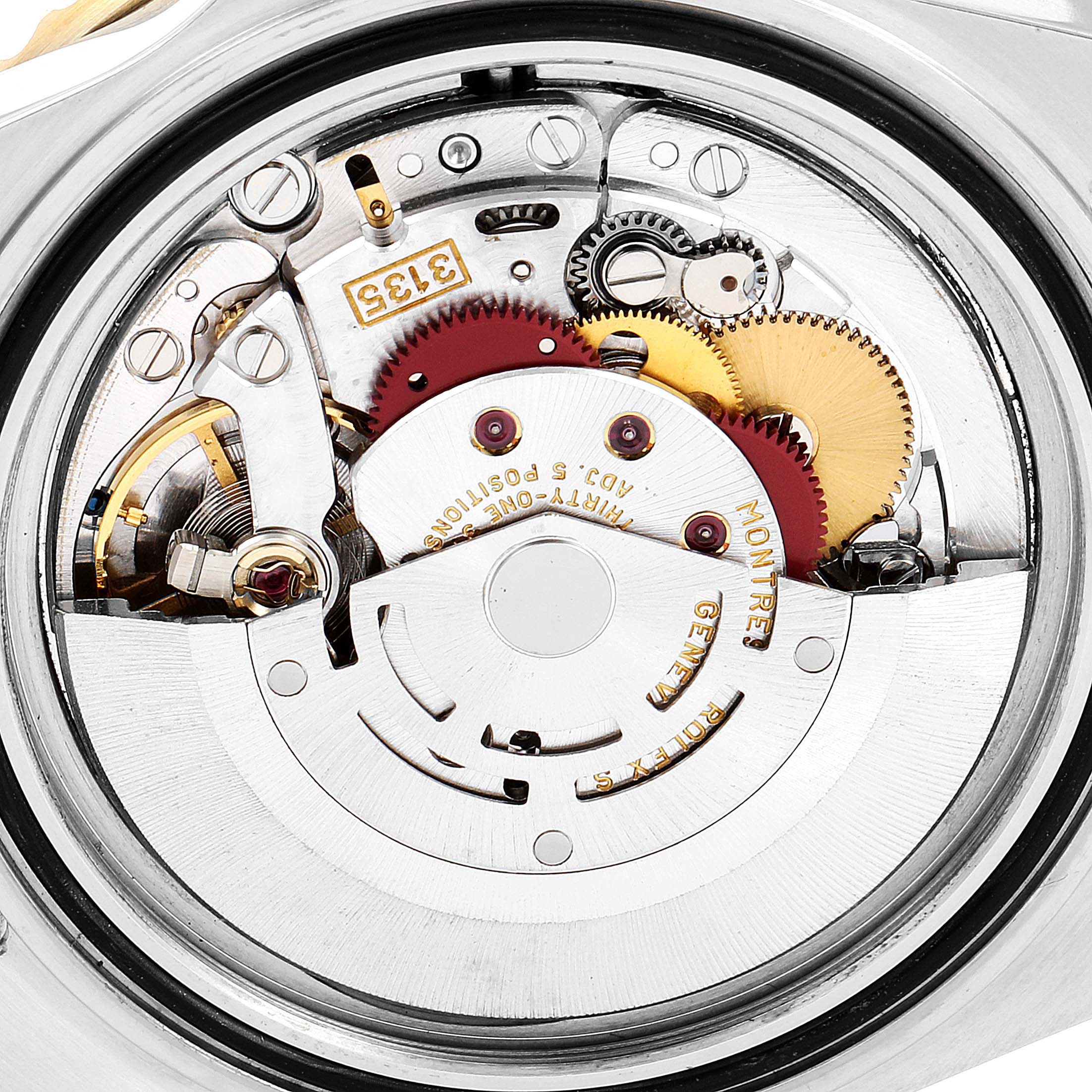 This image shows the intricate movement and internal mechanism of a Rolex Submariner 16613 Men
s Steel and Gold (two tone) Blue Dial 16613 Men
s Steel and Gold (two tone) Blue Dial watch.