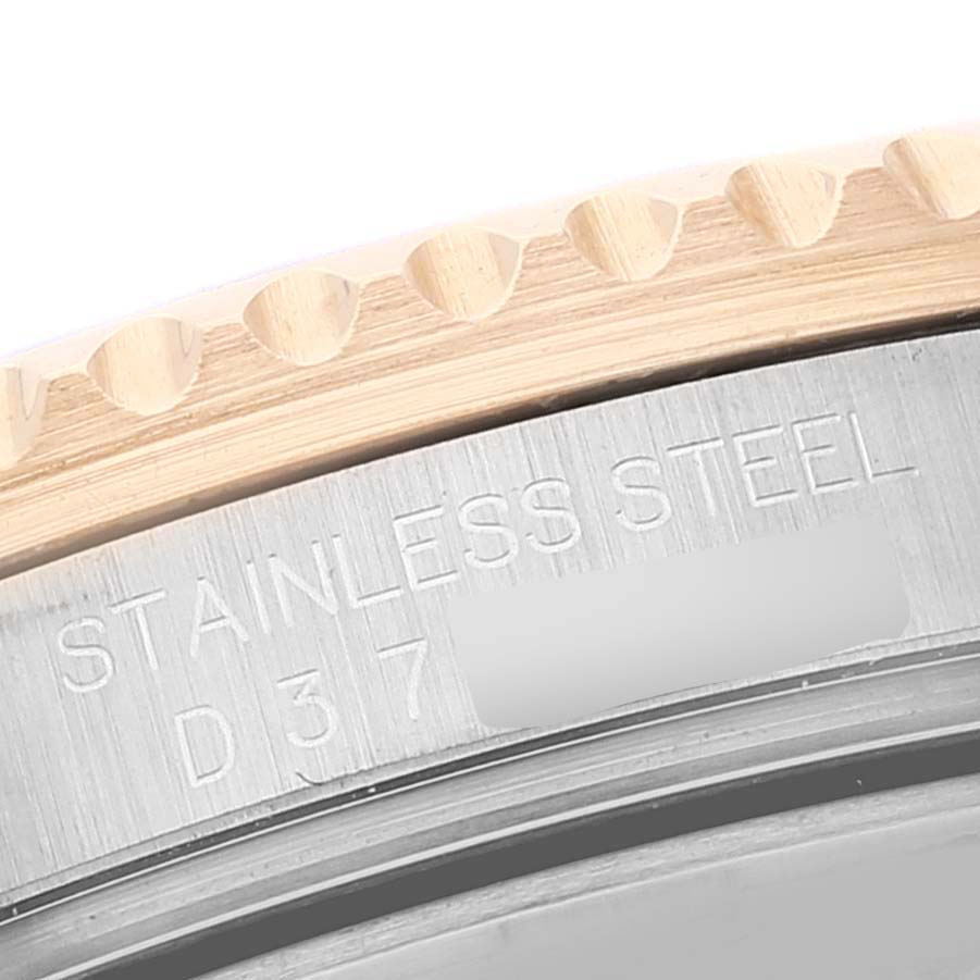 This close-up shows the stainless steel and gold bezel of a Rolex Submariner 16613 Men's Steel and Gold (two tone) Blue Dial 16613 Men's Steel and Gold (two tone) Blue Dial watch, highlighting the engraved text.