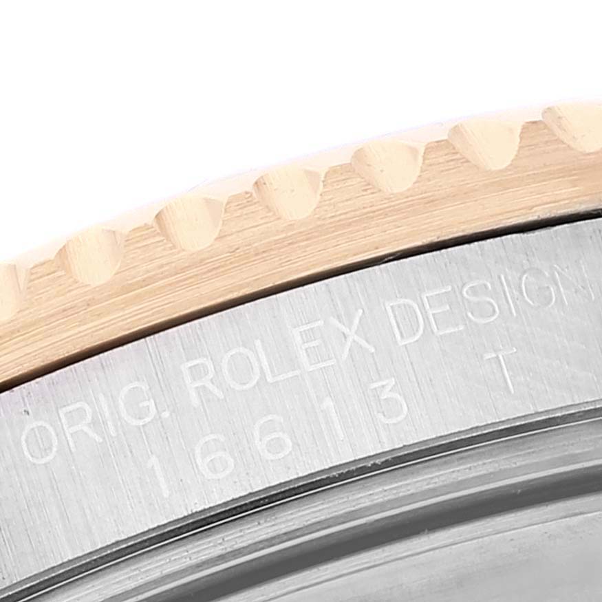 This image shows a close-up of the engraved bezel and casing of a Rolex Submariner 16613 Men's Steel and Gold (two tone) Blue Dial 16613 Men's Steel and Gold (two tone) Blue Dial watch.