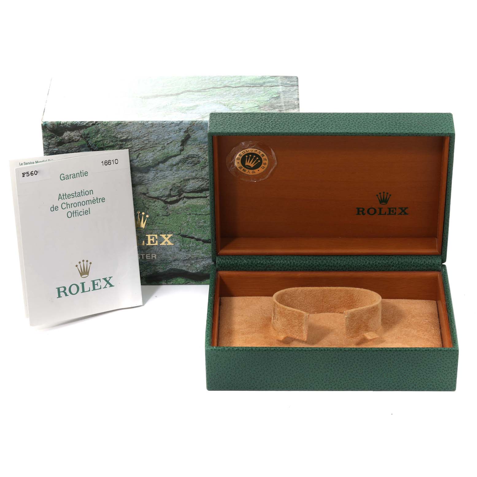 The image shows an open Rolex Submariner 16610 Men
s Stainless Steel Black Dial 16610 Men
s Stainless Steel Black Dial watch box with its cushion, and a manual or certificate is displayed next to it.