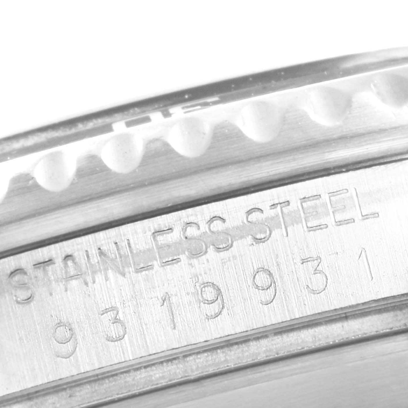 The image shows a close-up of the case side of a Rolex Submariner 16800 Men
s Stainless Steel Black Dial 16800 Men
s Stainless Steel Black Dial watch, highlighting the "STAINLESS STEEL" engraving.