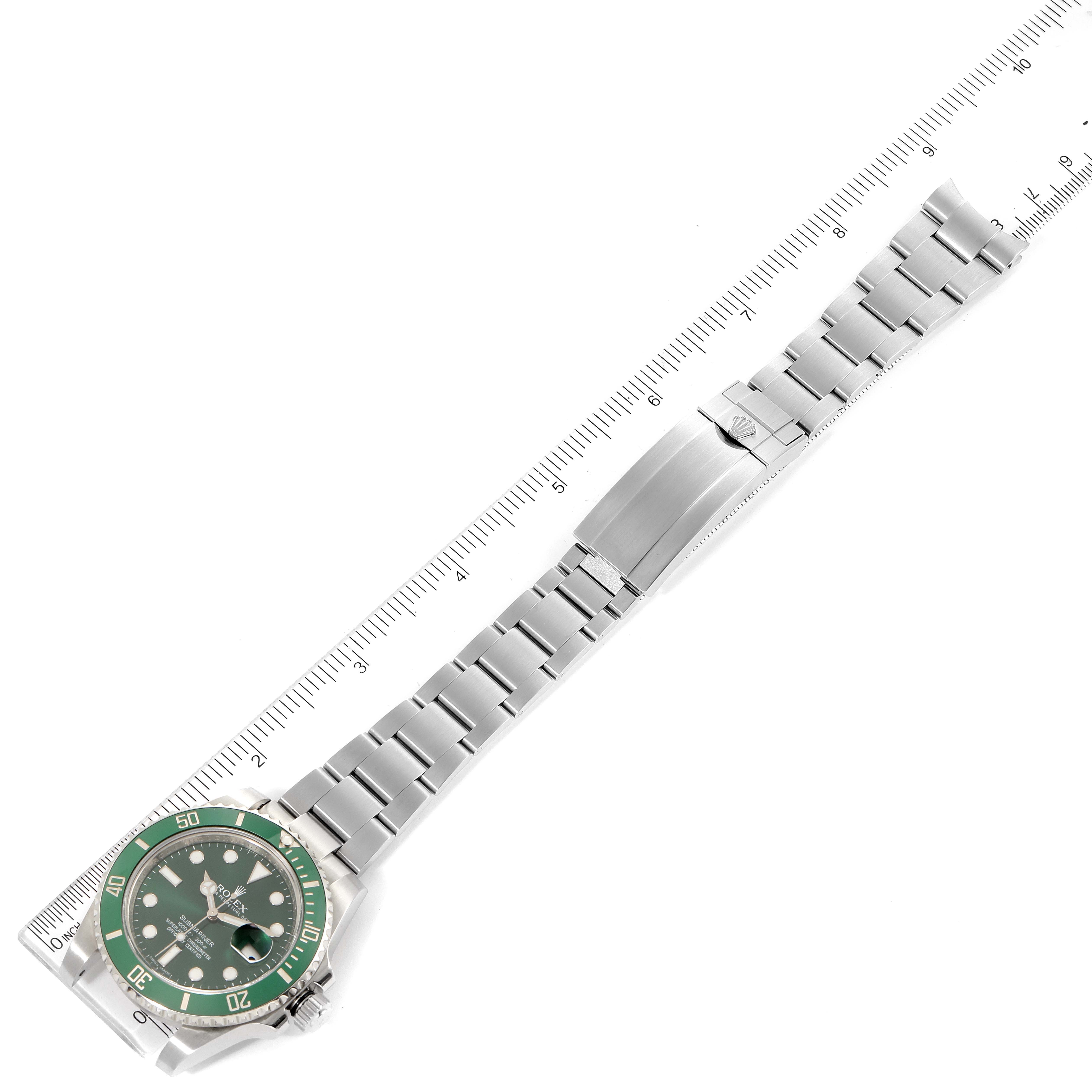 The Rolex Submariner 116610LV Men
s Stainless Steel Green Dial 116610LV Men
s Stainless Steel Green Dial watch is shown from a top-down angle, displaying the entire bracelet and green bezel face alongside a ruler.