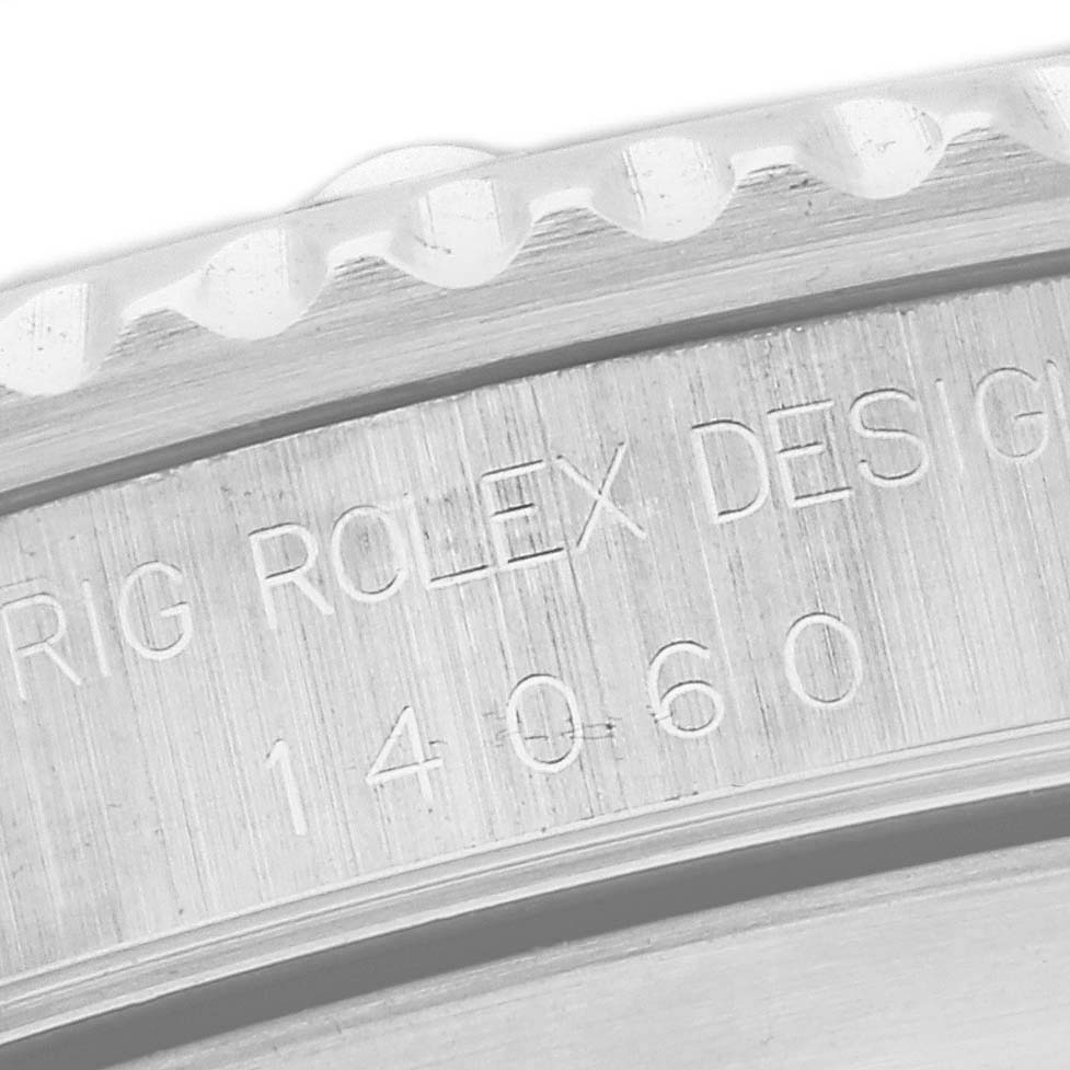This close-up image shows the engraved side of the bezel and part of the case of a Rolex Submariner 14060 Men
s Stainless Steel Black Dial 14060 Men
s Stainless Steel Black Dial watch with the model number 14060.