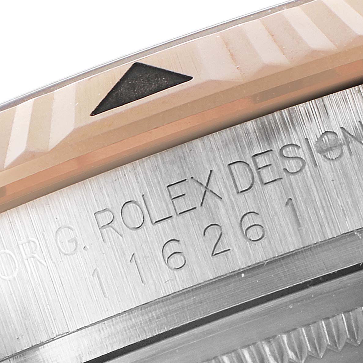 The image shows a close-up of the bezel and part of the casing of the Rolex Turn-o-Graph 116261 Men
s Steel and Gold (two tone) Black Dial 116261 Men
s Steel and Gold (two tone) Black Dial model with visible engravings.