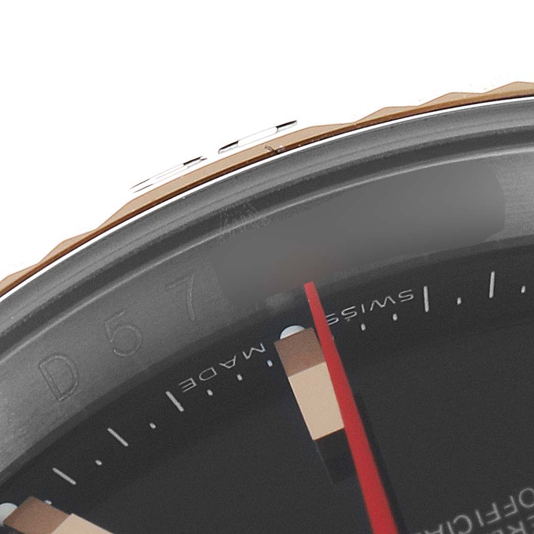 The image shows a close-up angle of the Rolex Turn-o-Graph 116261 Men
s Steel and Gold (two tone) Black Dial 116261 Men
s Steel and Gold (two tone) Black Dial watch dial and bezel, highlighting the markings and part of the minute hand.