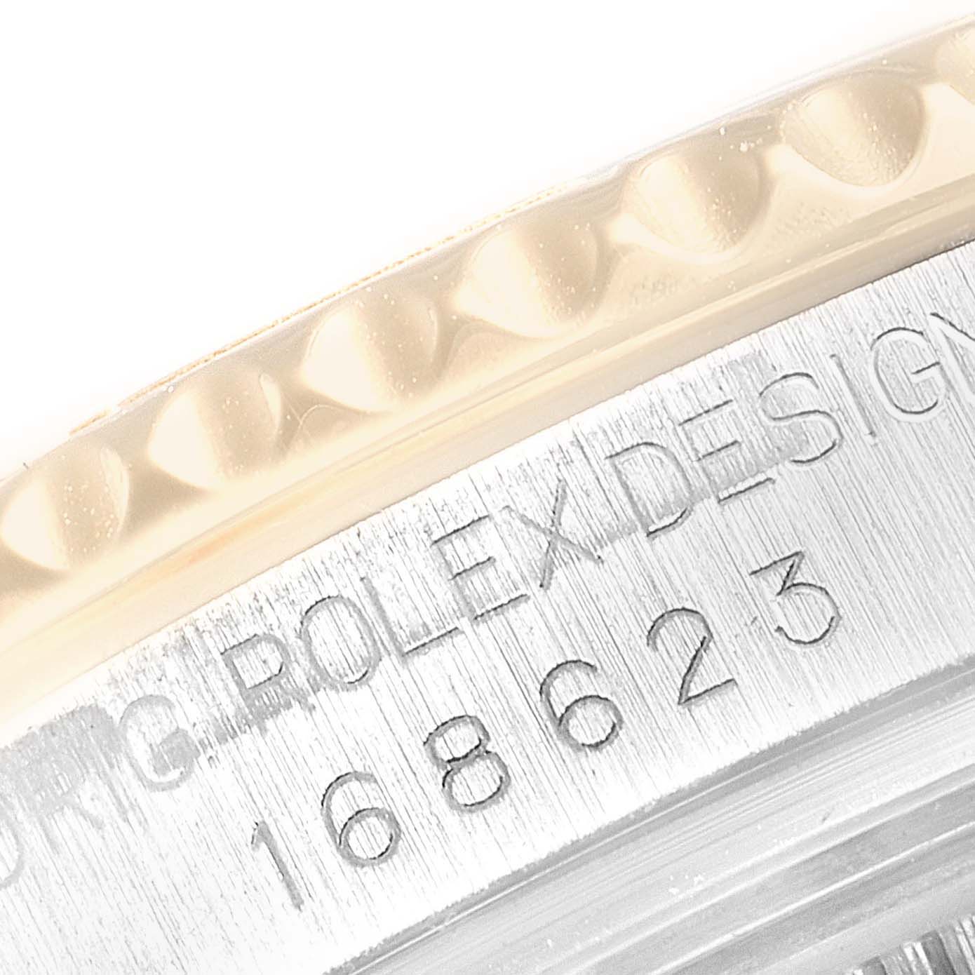 This close-up image shows the side of the bezel and engraved case of a Rolex Yacht-Master 168623 Men
s Steel and Gold (two tone) Blue Dial 168623 Men
s Steel and Gold (two tone) Blue Dial watch.