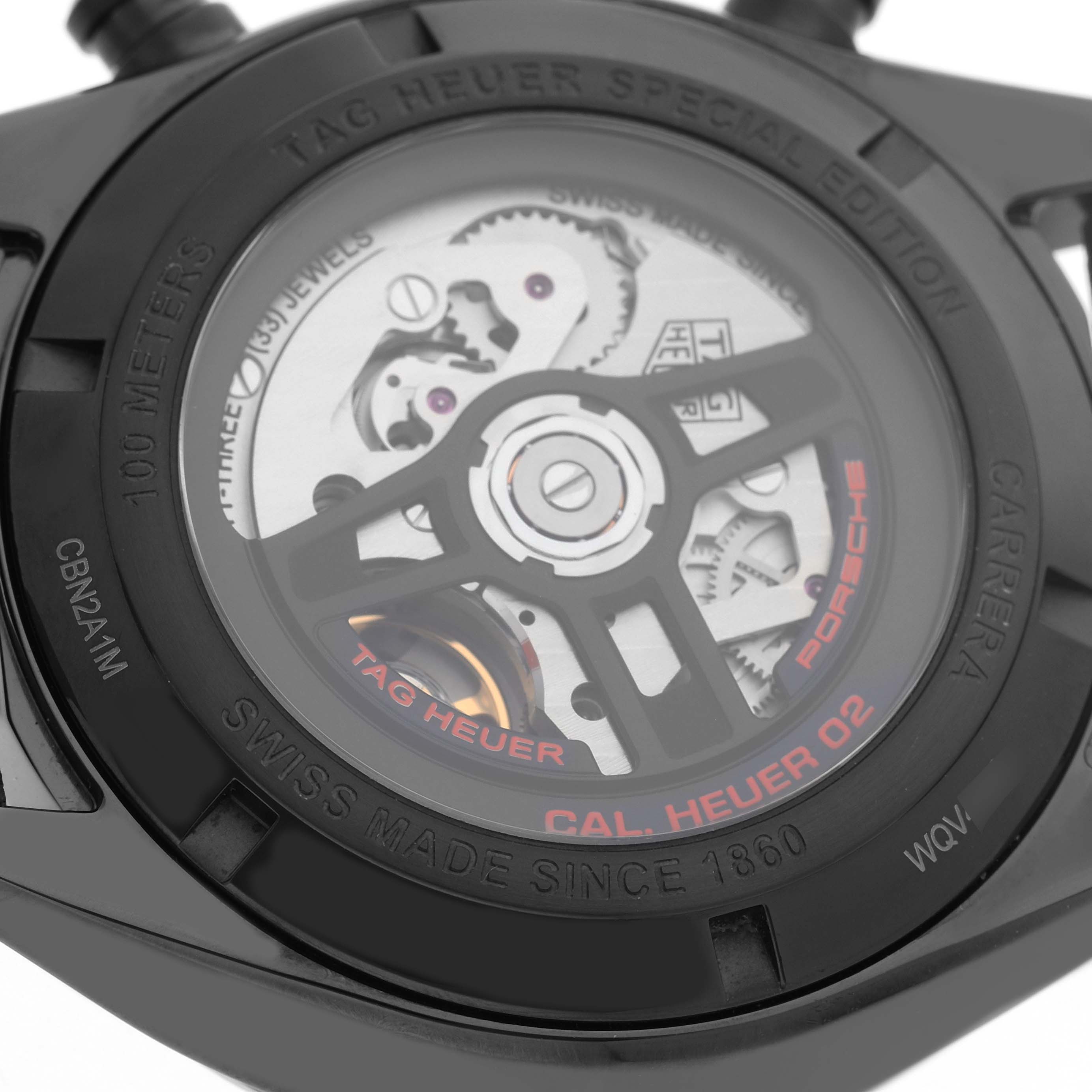 The image shows the back of a Tag Heuer Carrera CBN2A1M.FC6526 Men's Stainless Steel Black Dial watch, highlighting the movement and special edition engravings.