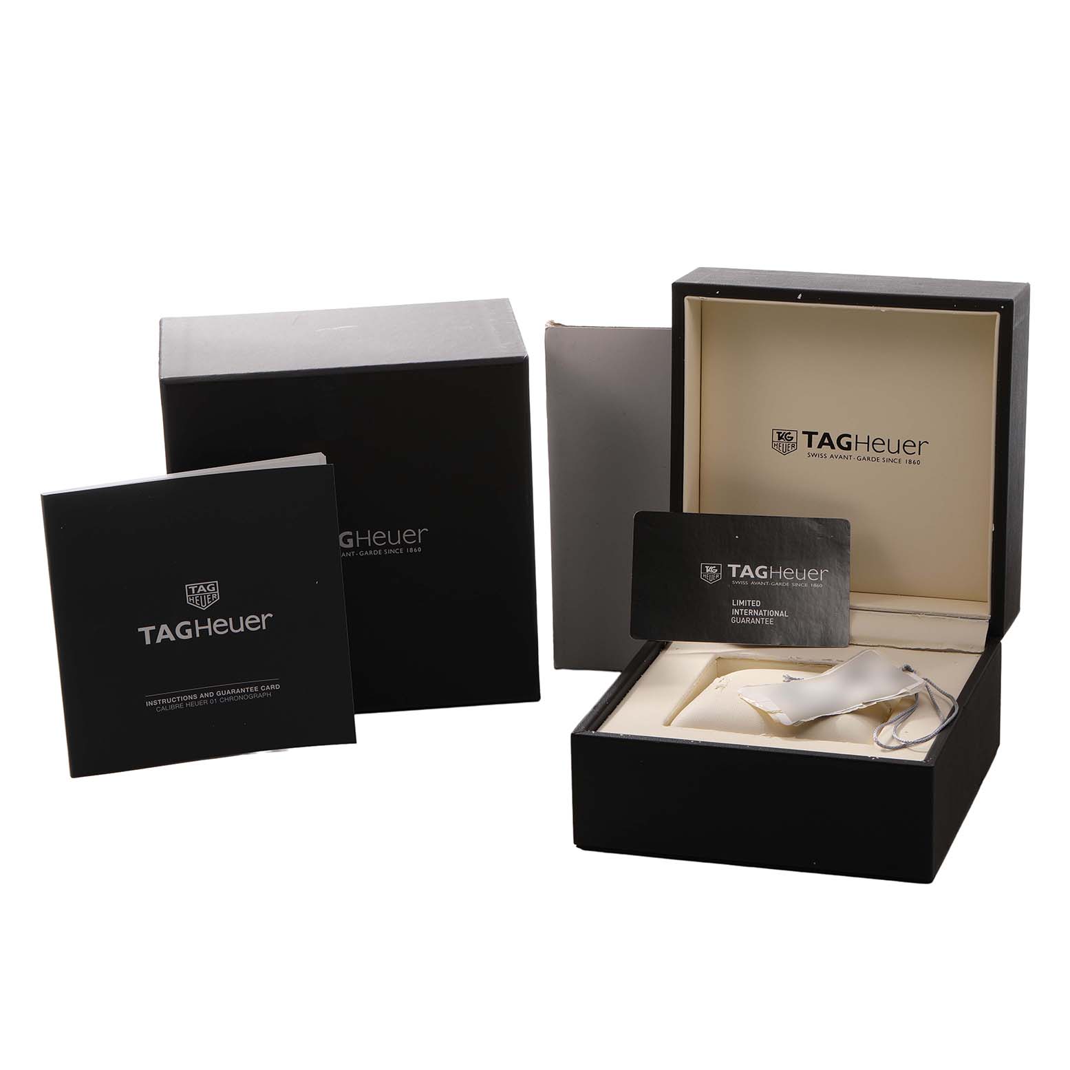 The image shows a TAG Heuer Carrera watch box set, including the box, outer packaging, manuals, and a warranty card.