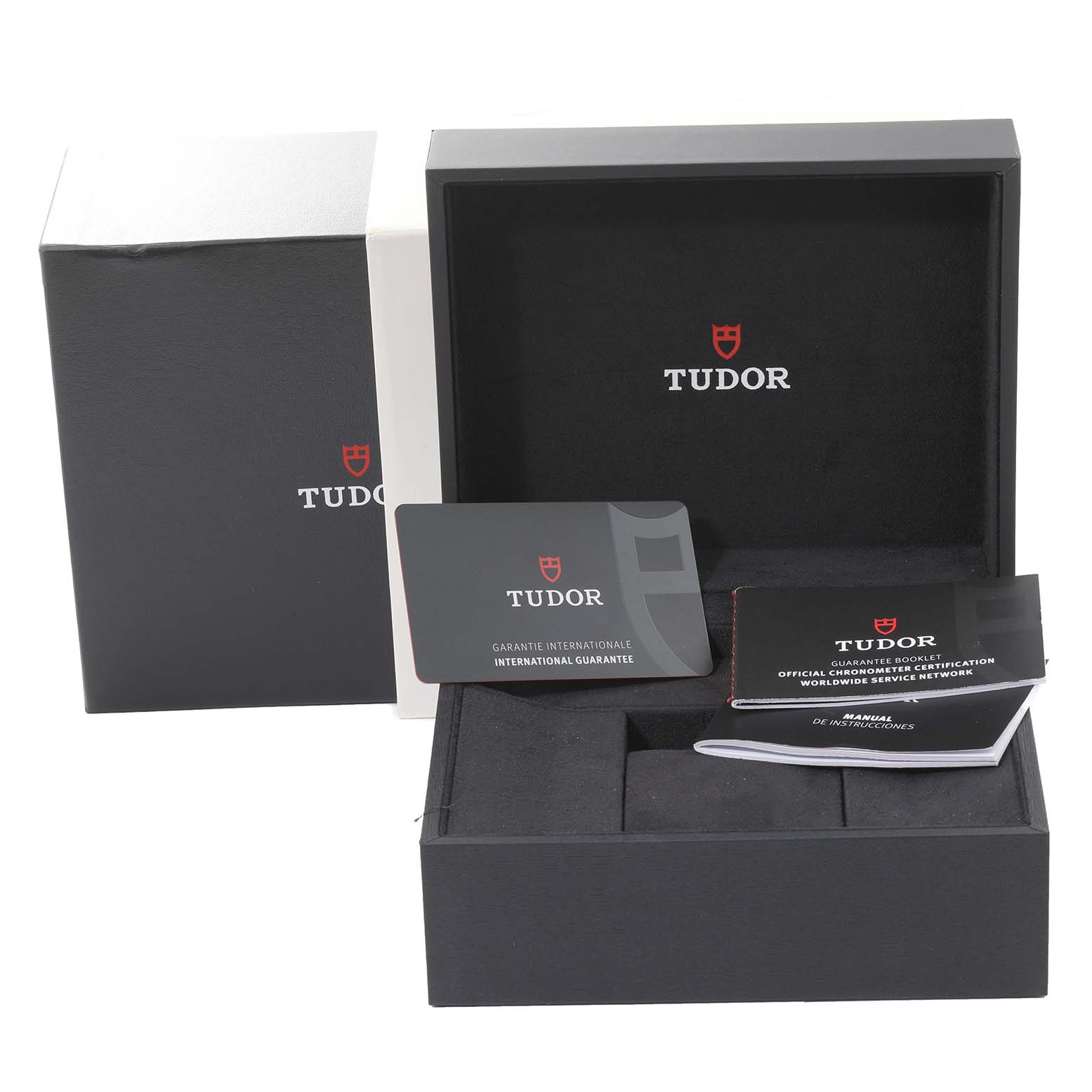 The image shows the packaging and accessories for the Tudor Heritage Black Bay M79030N-0002 Men
s Stainless Steel Black Dial M79030N-0002 Men
s Stainless Steel Black Dial watch, including the box, warranty card, and booklets.