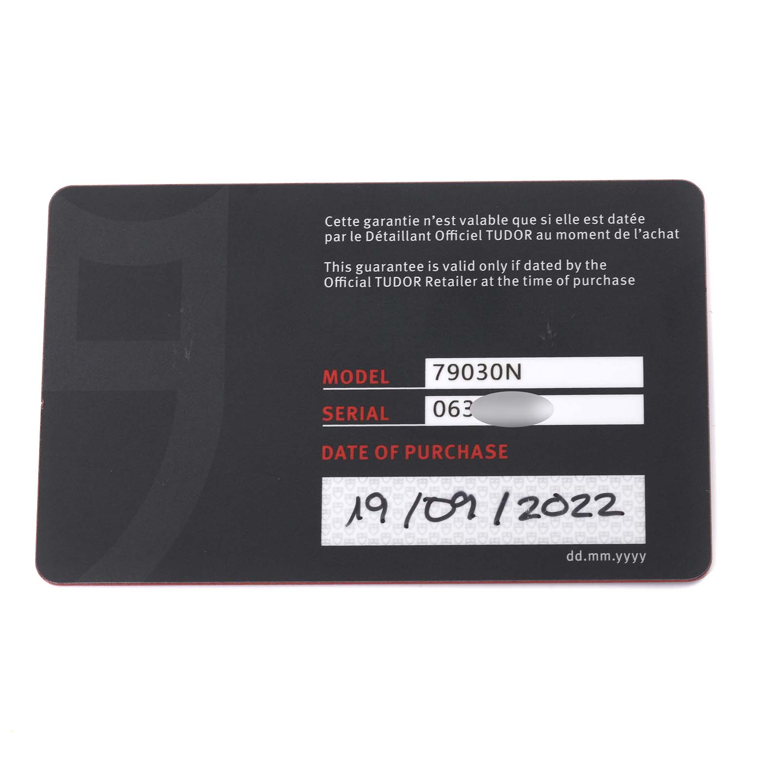 This is an image of a warranty card for a Tudor Heritage Black Bay M79030N-0002 Men
s Stainless Steel Black Dial M79030N-0002 Men
s Stainless Steel Black Dial model 79030N, showing model, serial number, and date of purchase.