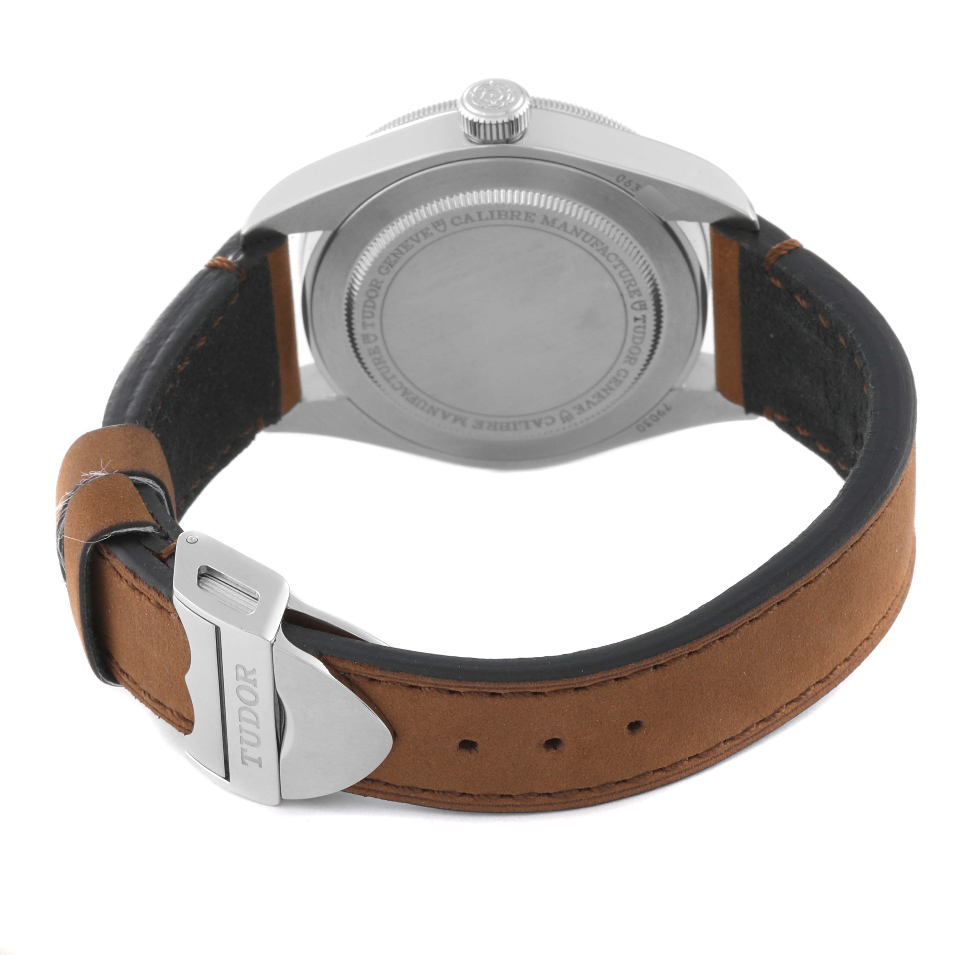 The image shows the back of a Tudor Heritage Black Bay M79030N-0002 Men
s Stainless Steel Black Dial M79030N-0002 Men
s Stainless Steel Black Dial watch, focusing on the case back and leather strap with a metal buckle.