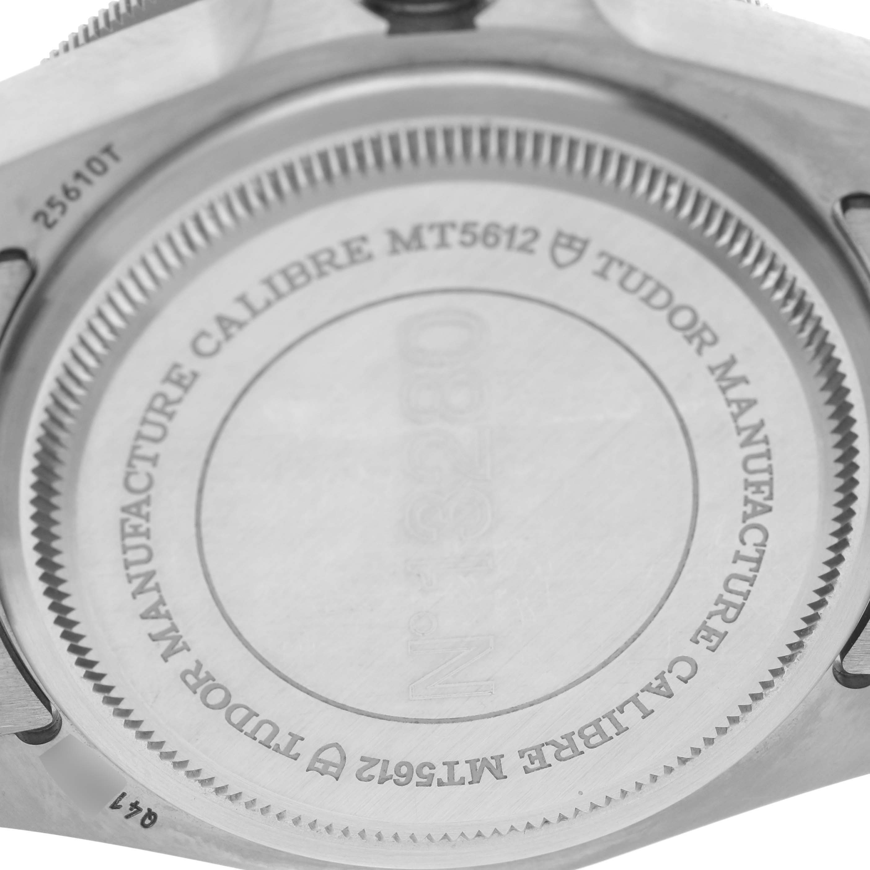 The image shows the case back of a Tudor Pelagos 25610TNL Men
s Stainless Steel Black Dial 25610TNL Men
s Stainless Steel Black Dial watch, highlighting the model inscription and manufacturer details.