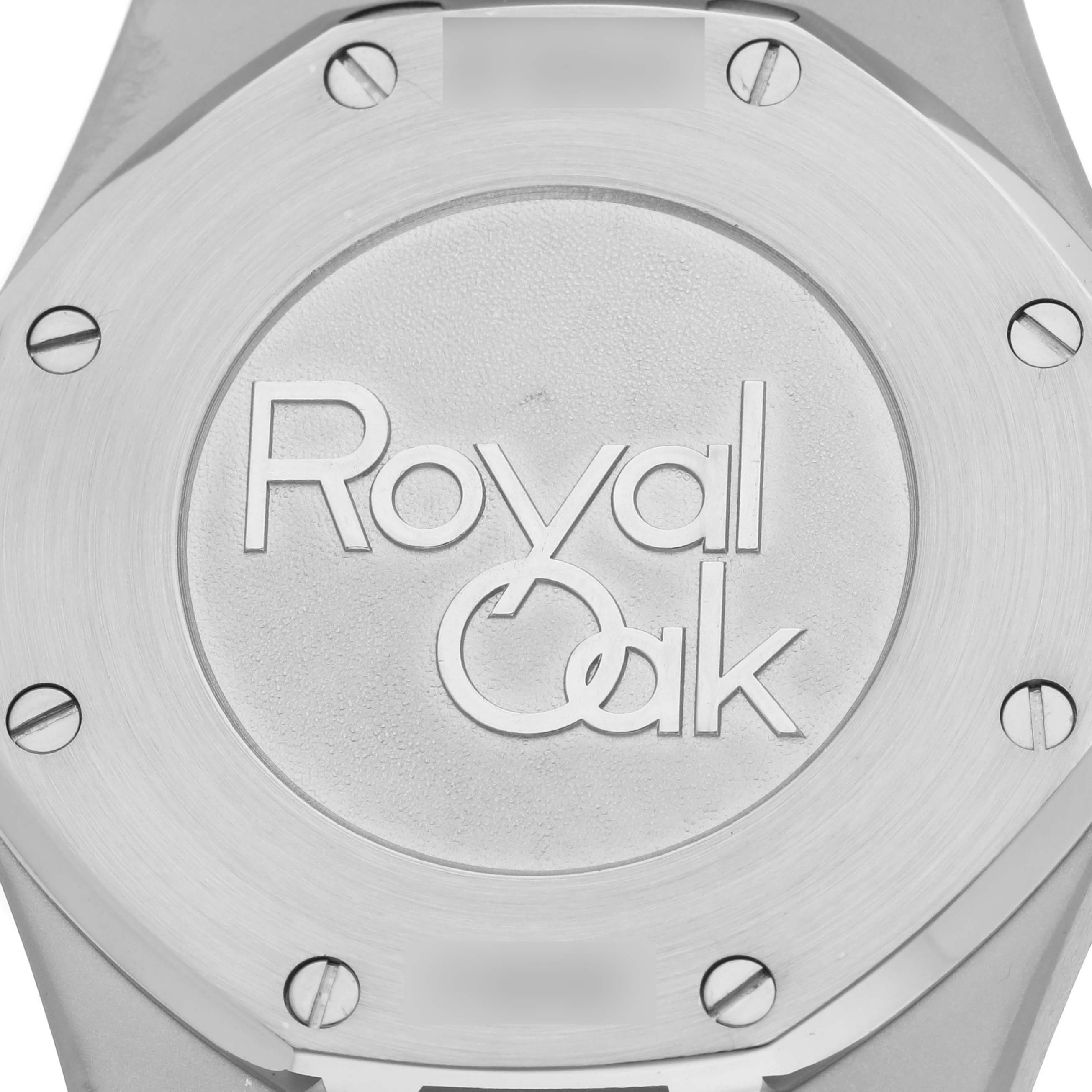 The image shows a close-up of the back of an Audemars Piguet Royal Oak 26120ST.00.1220ST.01 Men's Stainless Steel Silver Dial 26120ST.00.1220ST.01 Men's Stainless Steel Silver Dial watch, highlighting the engraving and screws.