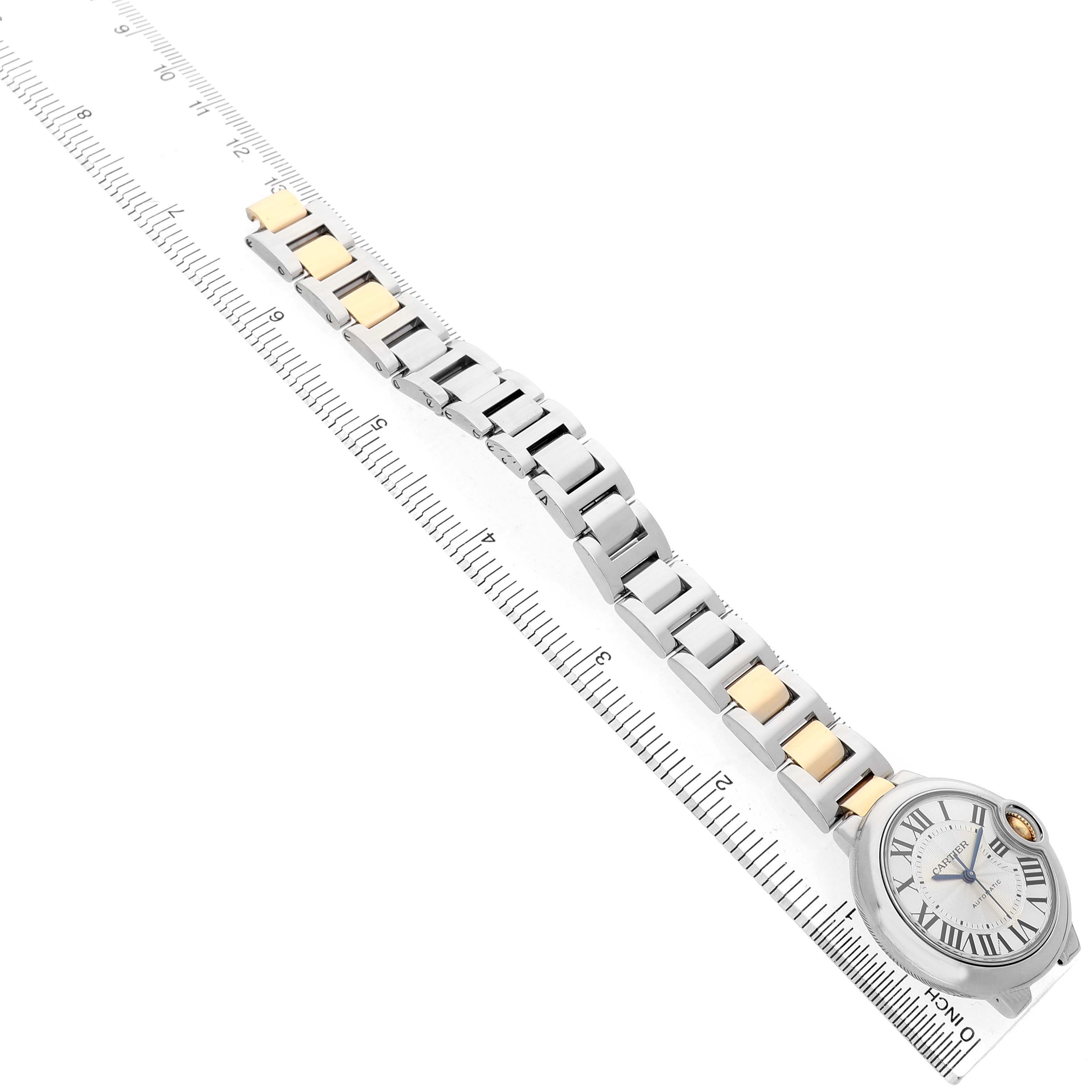 The Cartier Ballon Bleu W2BB0002 Women's Steel and Gold (two tone) Silver Dial watch is shown in a side view, displaying the face, band, and a ruler for scale.