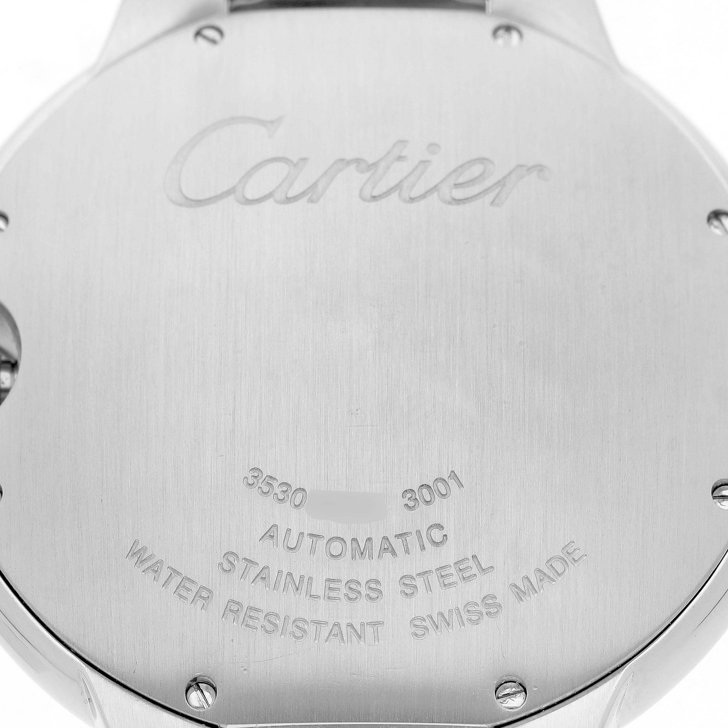The image shows the back case of a Cartier Ballon Bleu W69012Z4 Men's Stainless Steel Silver Dial watch, displaying engravings and screws.