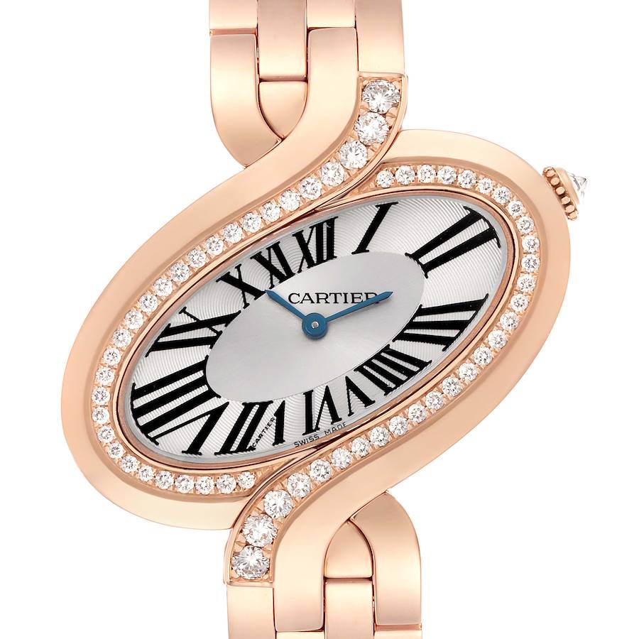 The Cartier Delices watch is shown from a front angle, highlighting the oval face, diamond bezel, and partial bracelet.