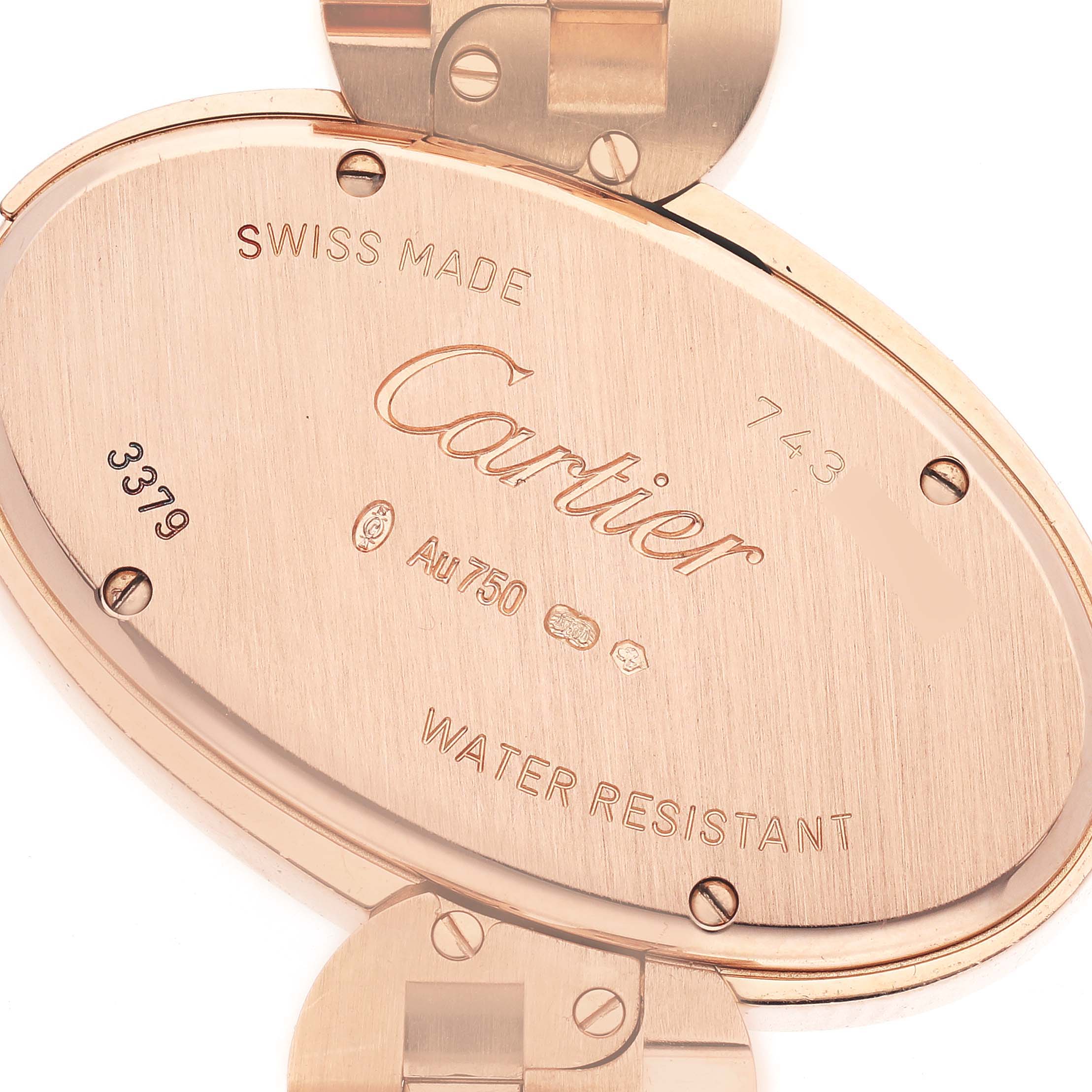 The image shows the back of the Cartier Delices WG800006 Women
s Rose Gold Silver Dial WG800006 Women
s Rose Gold Silver Dial watch, featuring the case back with engraved details and part of the clasp.
