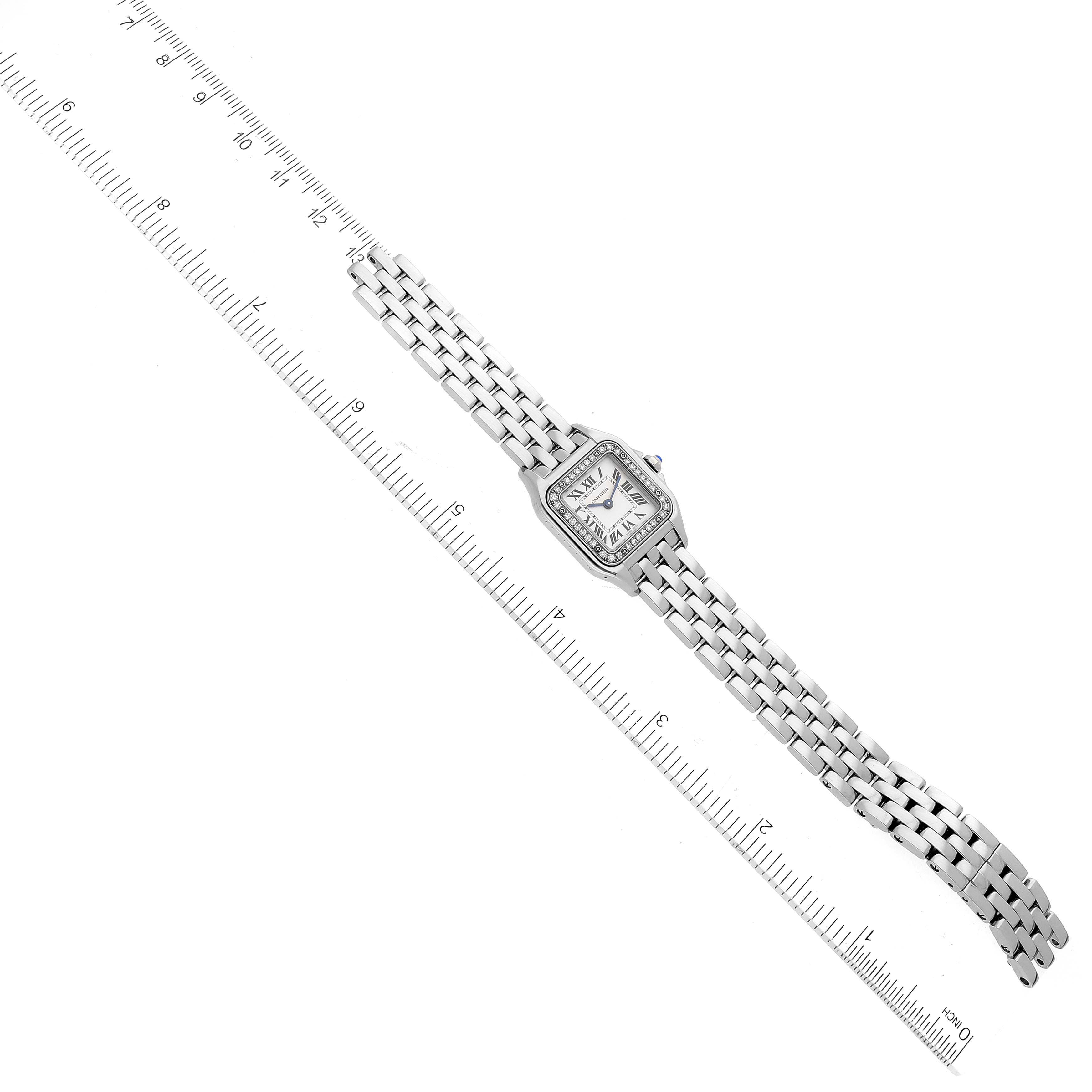 The image shows a top-down view of a Cartier Panthere W4PN0007 Women
s Stainless Steel Silver Dial W4PN0007 Women
s Stainless Steel Silver Dial watch placed next to a ruler for scale.