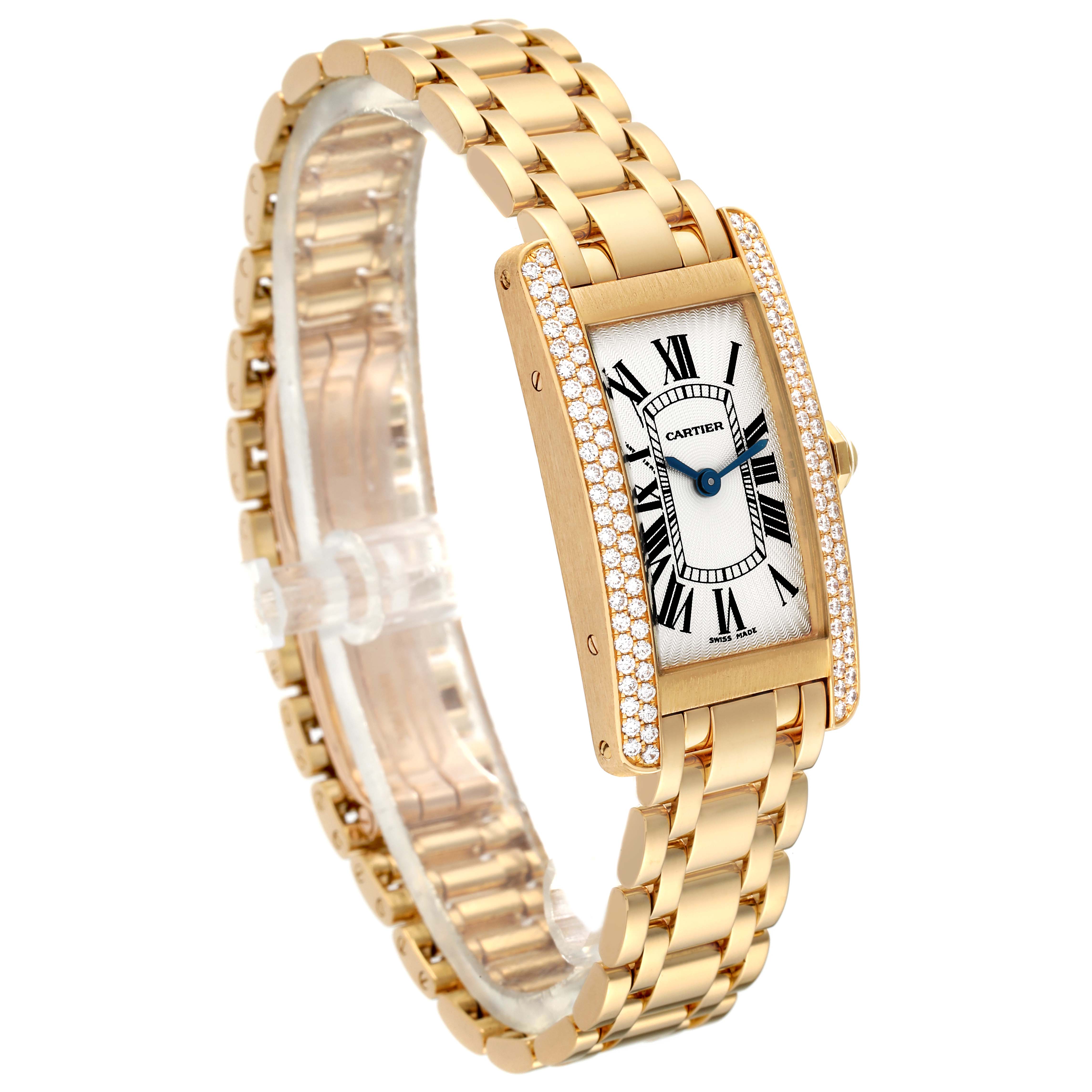 This image shows an angled view of a Cartier Tank Americaine WB7012K2 Women's Yellow Gold Silver Dial WB7012K2 Women's Yellow Gold Silver Dial watch, highlighting its gold bracelet and rectangular, diamond-encrusted case.