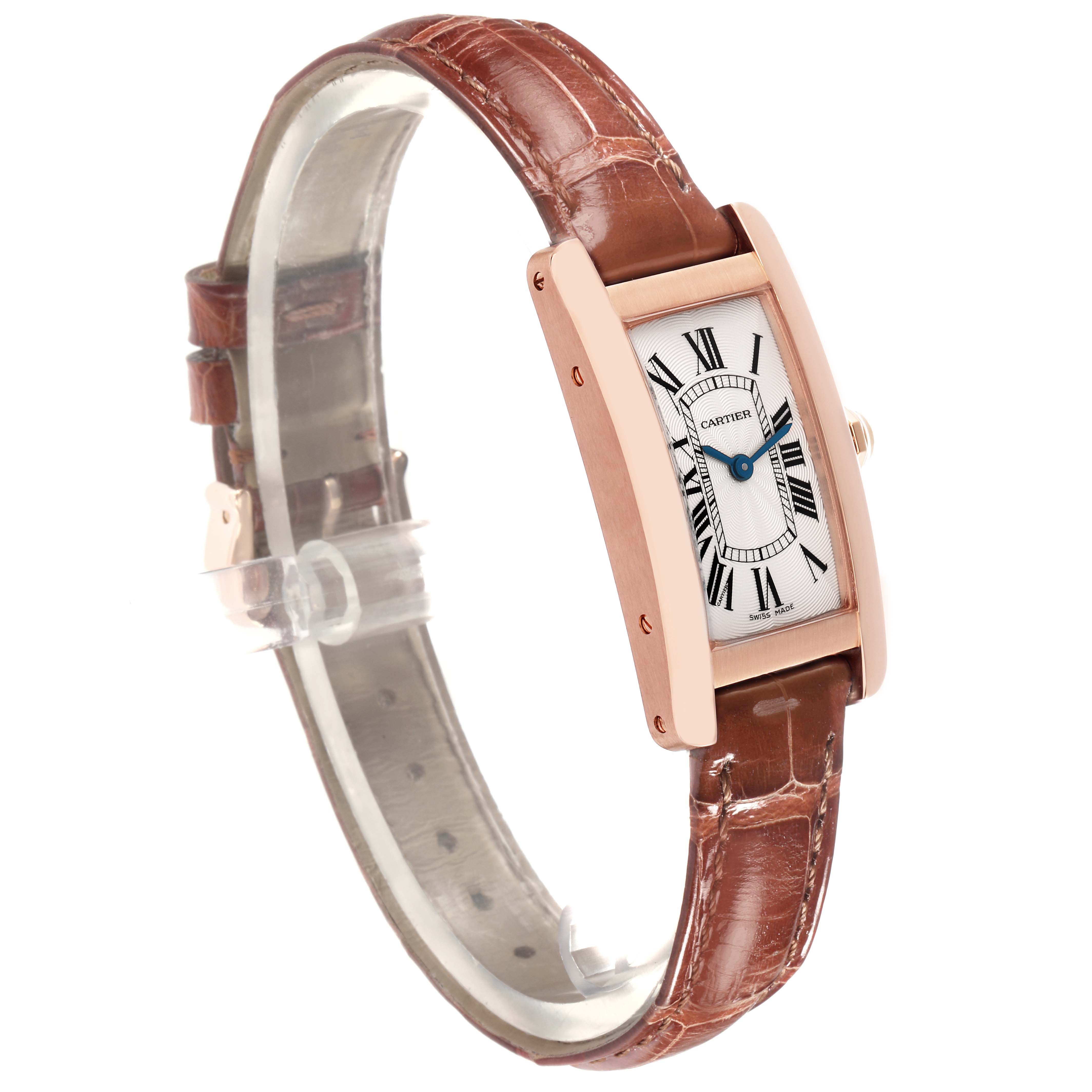 The Cartier Tank Americaine W2607456 Women's Rose Gold Silver Dial W2607456 Women's Rose Gold Silver Dial watch is shown at a three-quarter angle, highlighting its elongated case and brown leather strap.