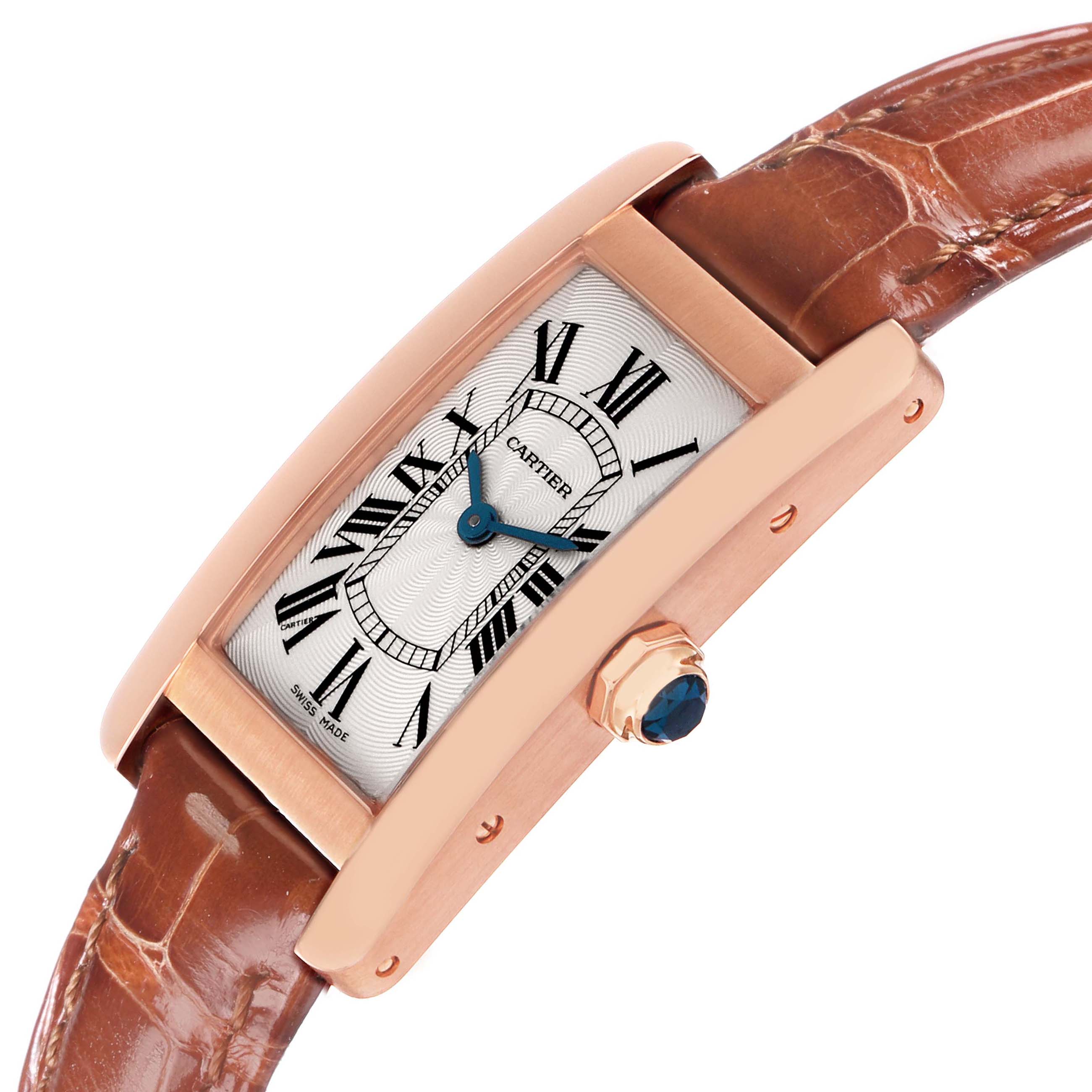 The Cartier Tank Américaine watch is shown at an angle displaying its rectangular face, Roman numerals, side crown, and leather strap.