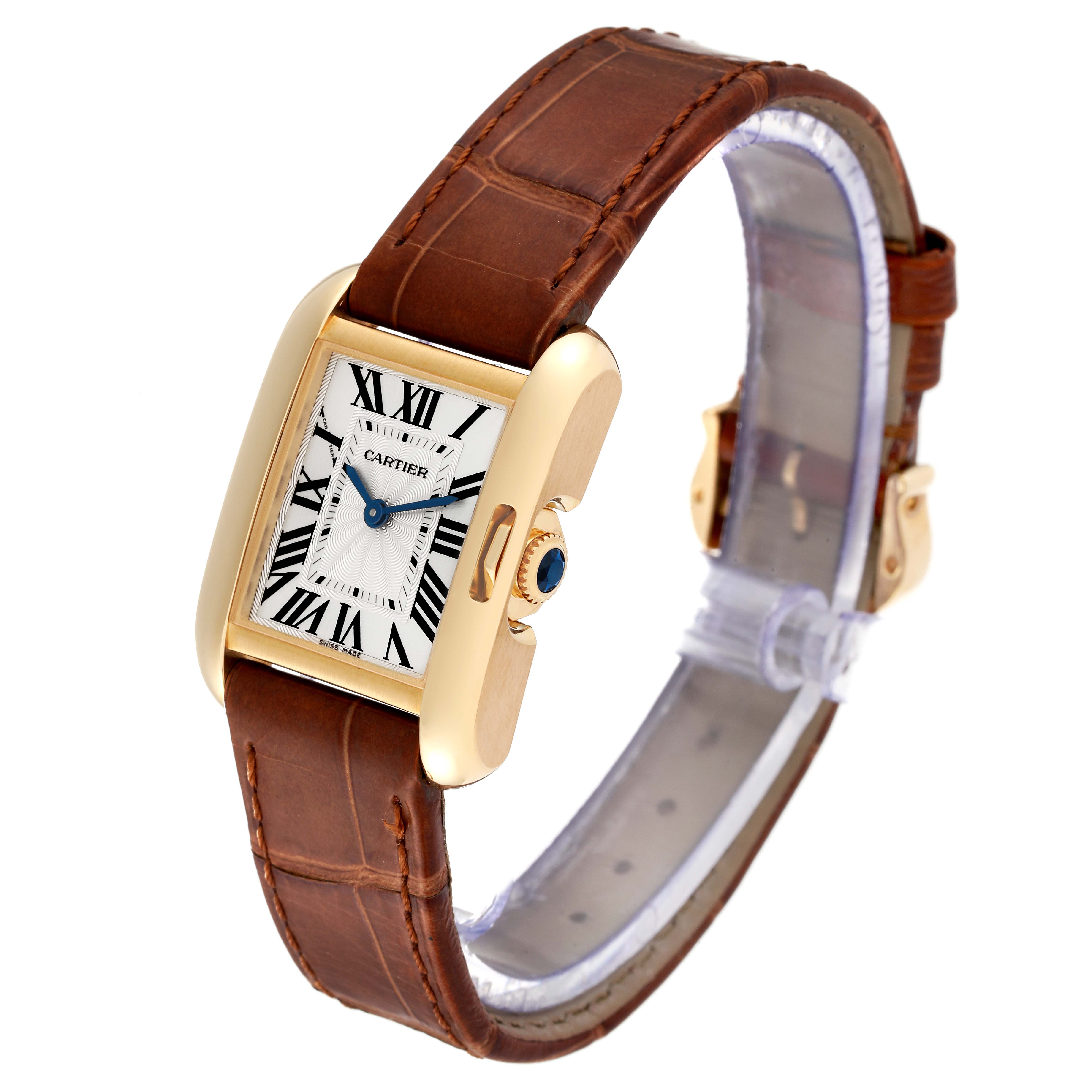 The Cartier Tank Anglaise W5310028 Women
s Yellow Gold Silver Dial W5310028 Women
s Yellow Gold Silver Dial watch is shown at an angled view, featuring the face, numerals, case, crown, and leather strap.