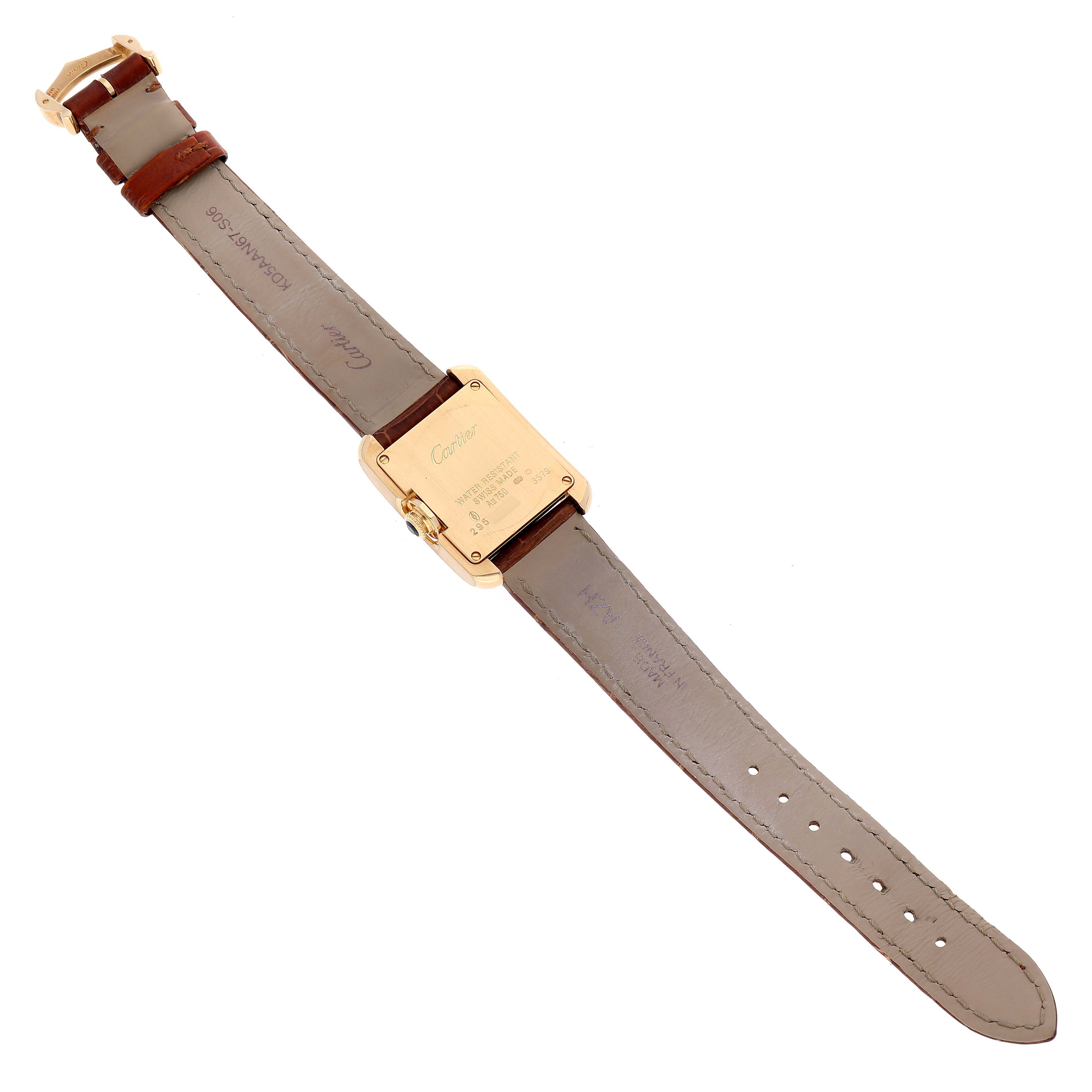 This image shows the back view of the Cartier Tank Anglaise W5310028 Women
s Yellow Gold Silver Dial W5310028 Women
s Yellow Gold Silver Dial watch with its leather strap fully laid out.