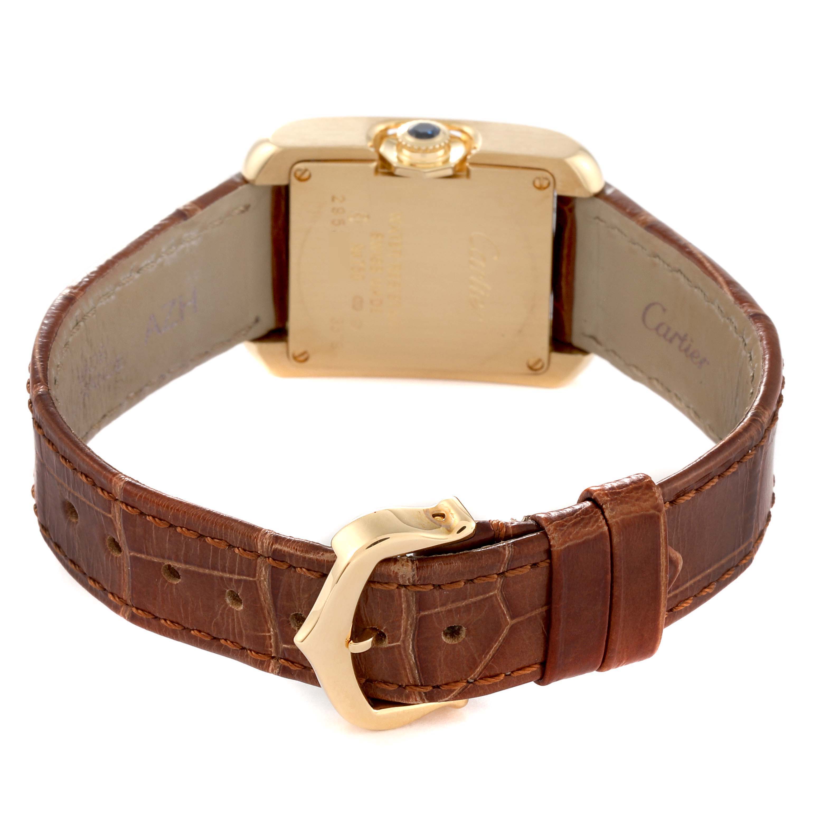 The image shows the back view of a Cartier Tank Anglaise W5310028 Women
s Yellow Gold Silver Dial W5310028 Women
s Yellow Gold Silver Dial watch, highlighting its gold case, brown leather strap, and clasp.