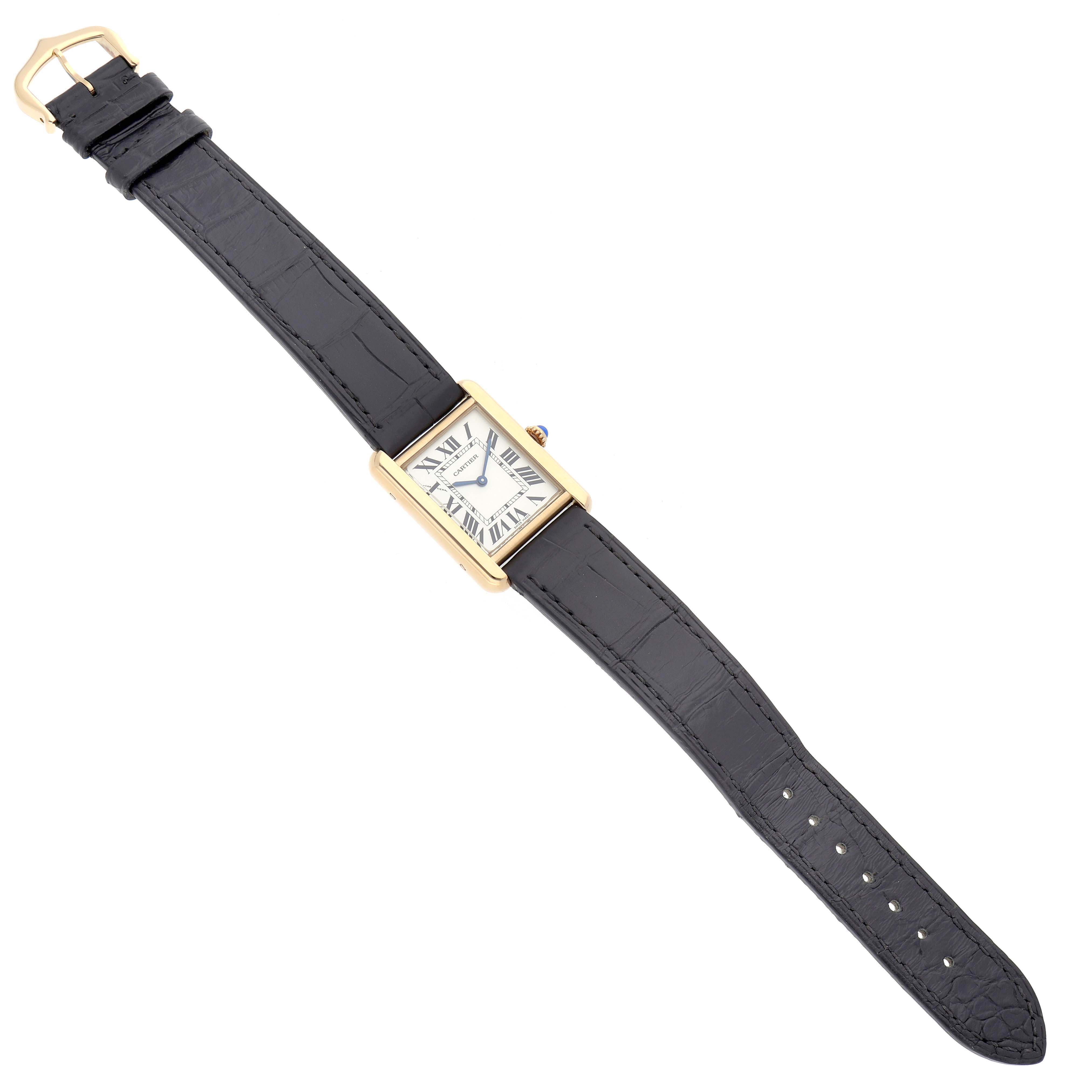 The Cartier Tank Solo model W5200002 is shown from an angled top-down view, displaying the face, case, crown, and entire black strap.