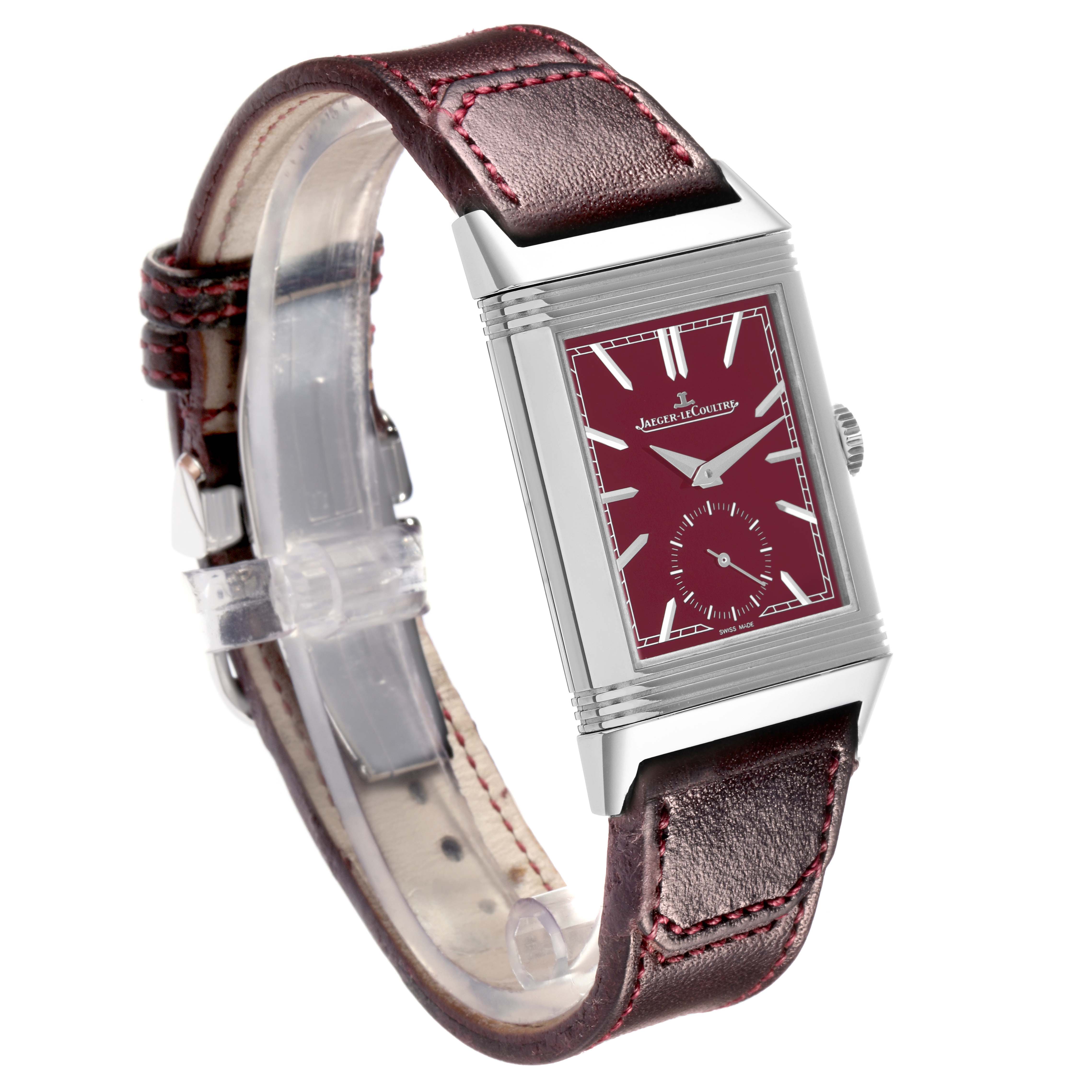 The Jaeger-LeCoultre Reverso watch is shown at a three-quarter angle highlighting the dial and leather strap.