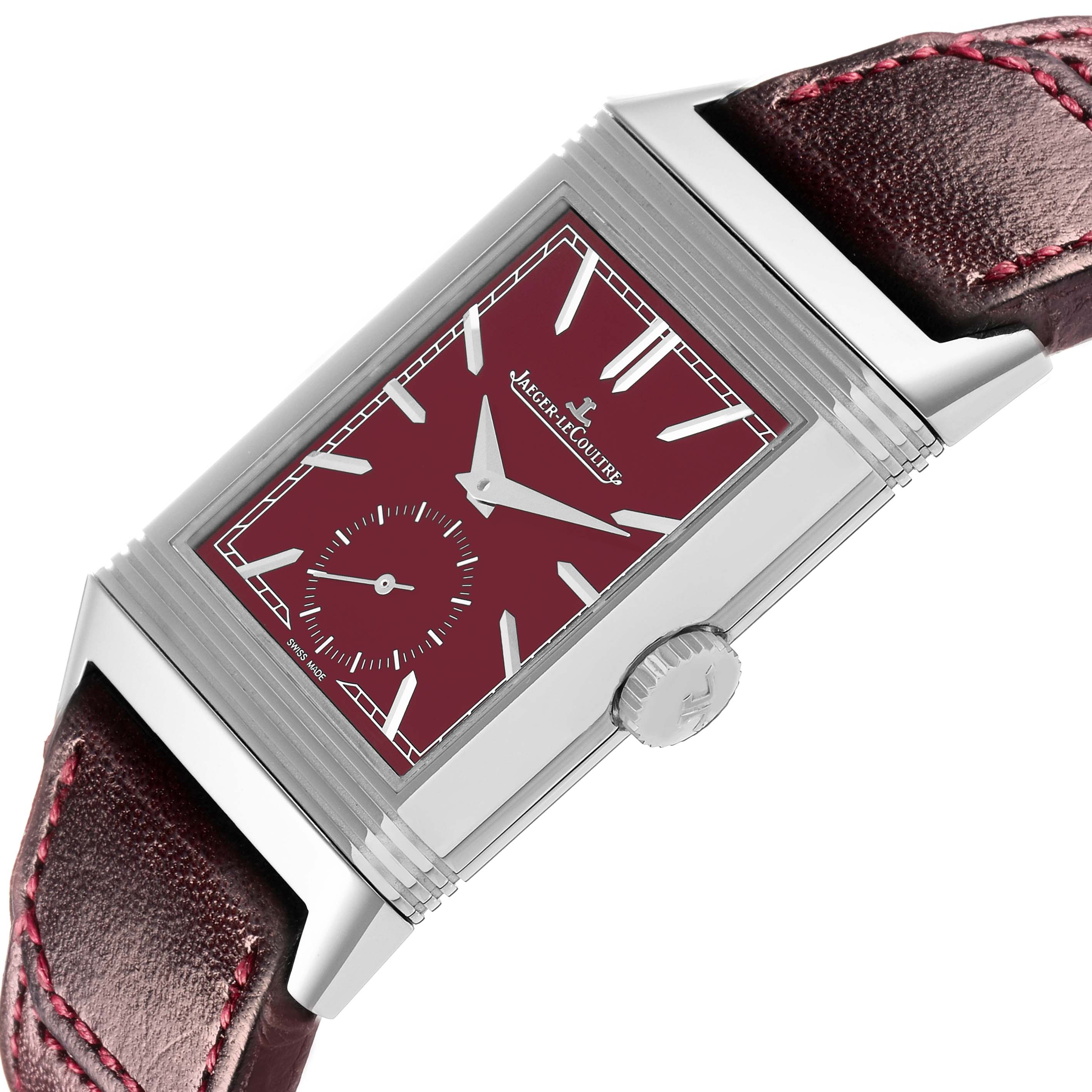 The Jaeger-LeCoultre Reverso watch is shown at a slight angle, highlighting its face, crown, and part of the leather strap.