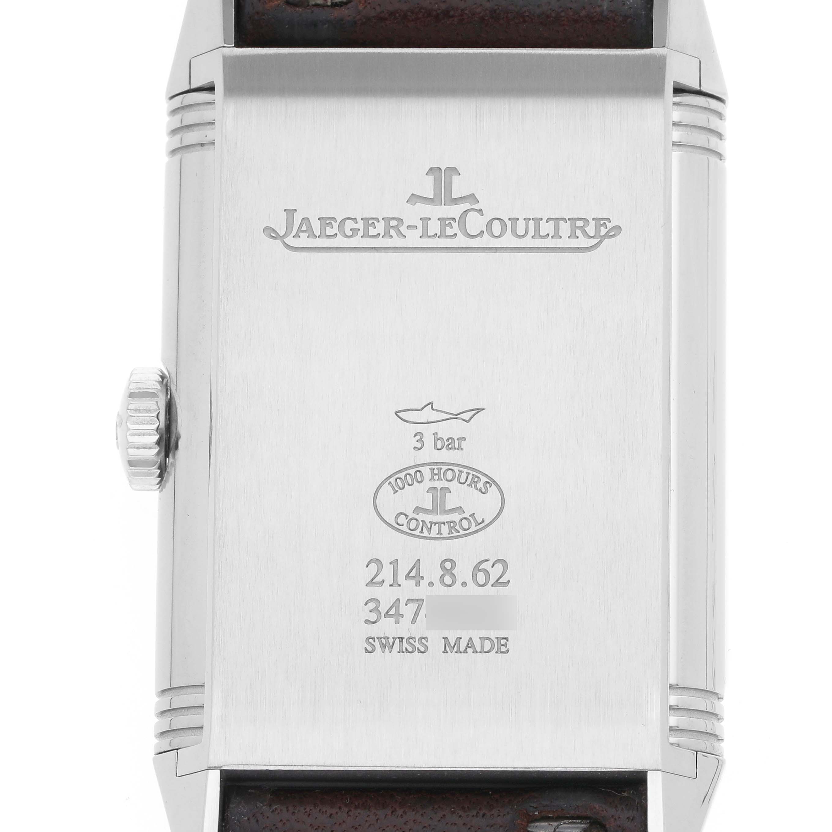 The image shows the back of the Jaeger-LeCoultre Reverso watch, featuring engravings and the crown on the left side.