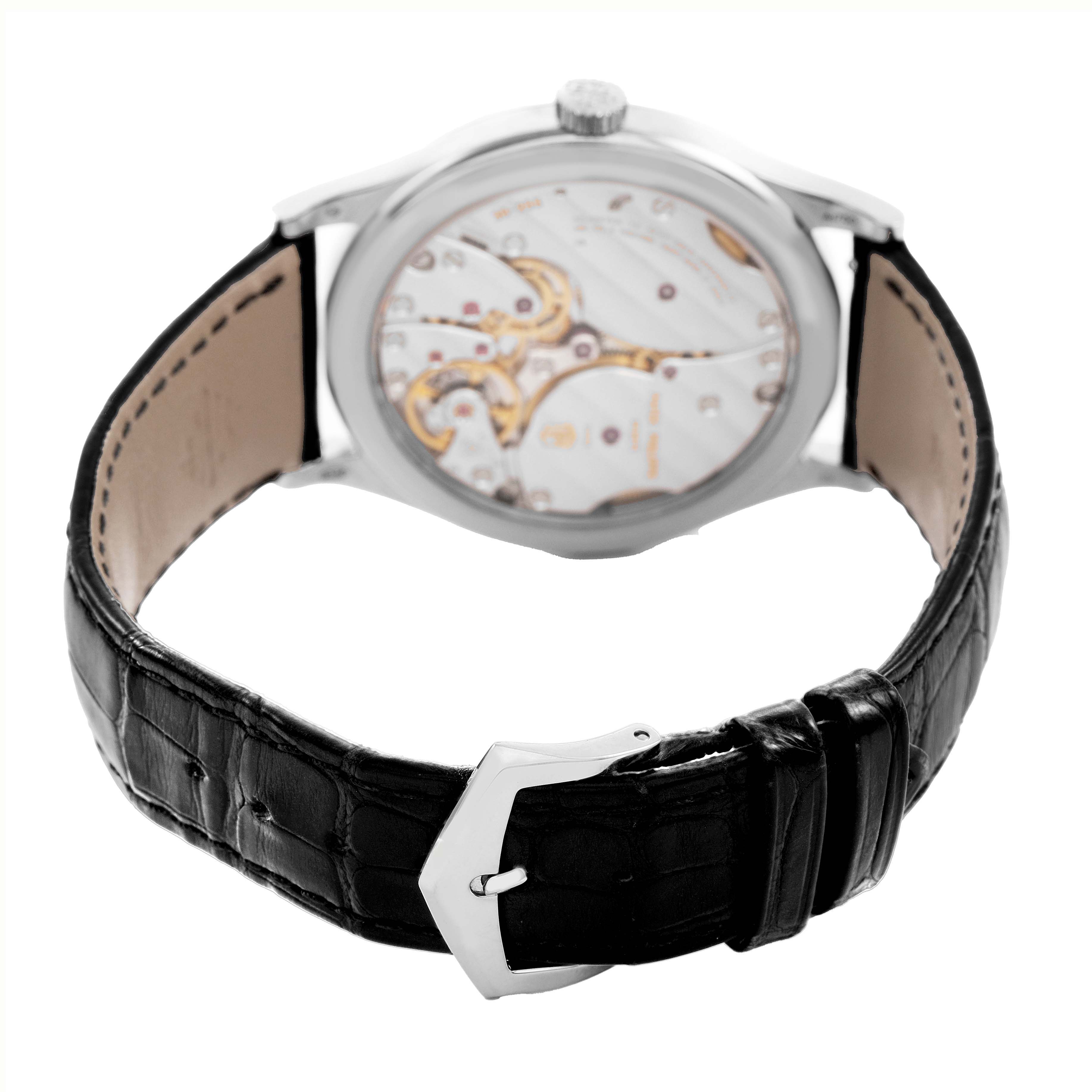 The image shows the back view of a Patek Philippe Calatrava 6119G-001 Men's White Gold Grey Dial watch, highlighting its movement and leather strap.