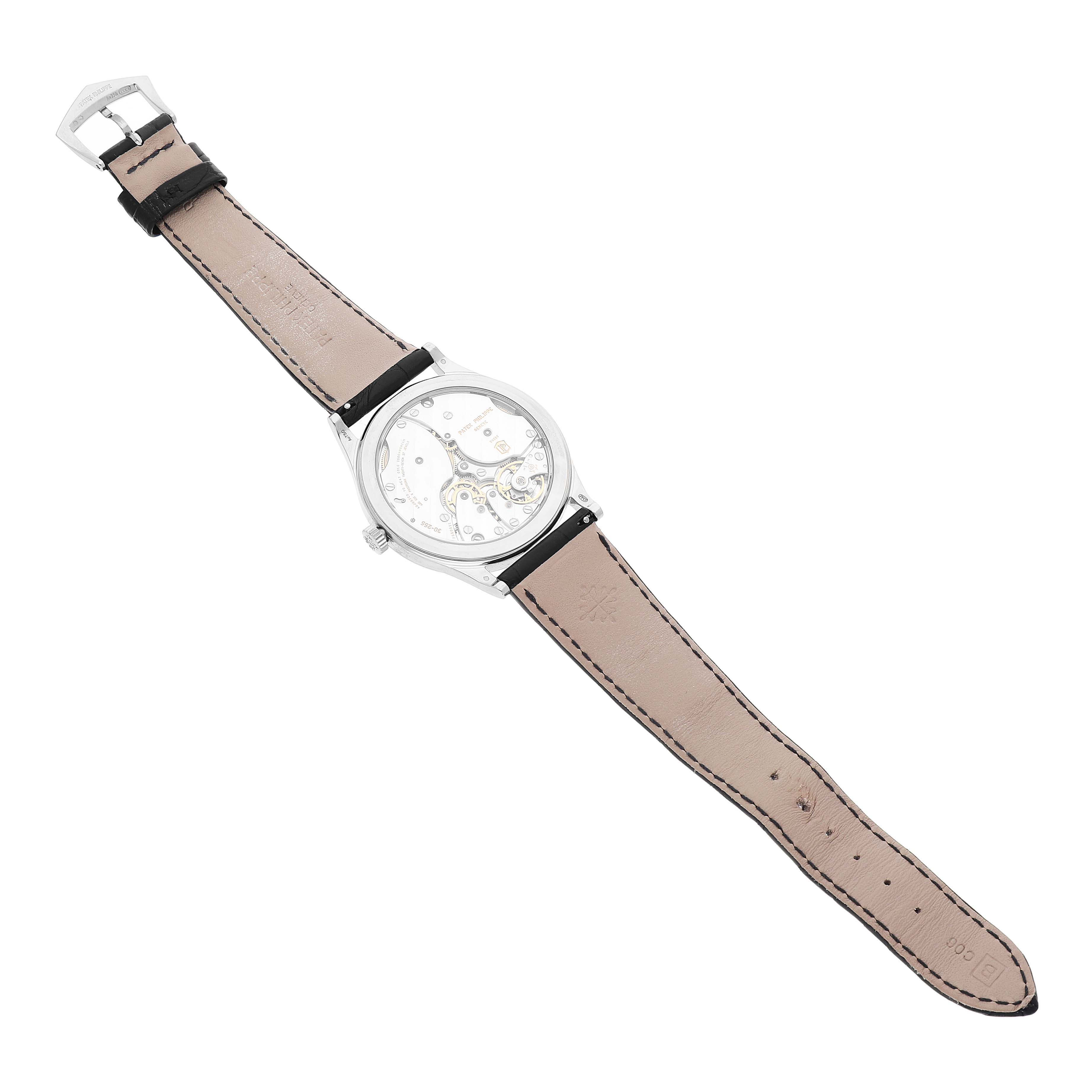 The Patek Philippe Calatrava 6119G-001 Men's White Gold Grey Dial watch is shown from the back, highlighting its transparent case back and leather strap.