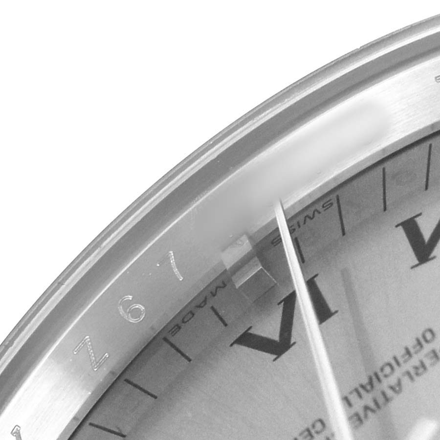 The image shows a close-up of the bezel and partial dial of the Rolex Air-King 114200 Men's Stainless Steel Silver Dial watch, highlighting the engraved details and hour markers.