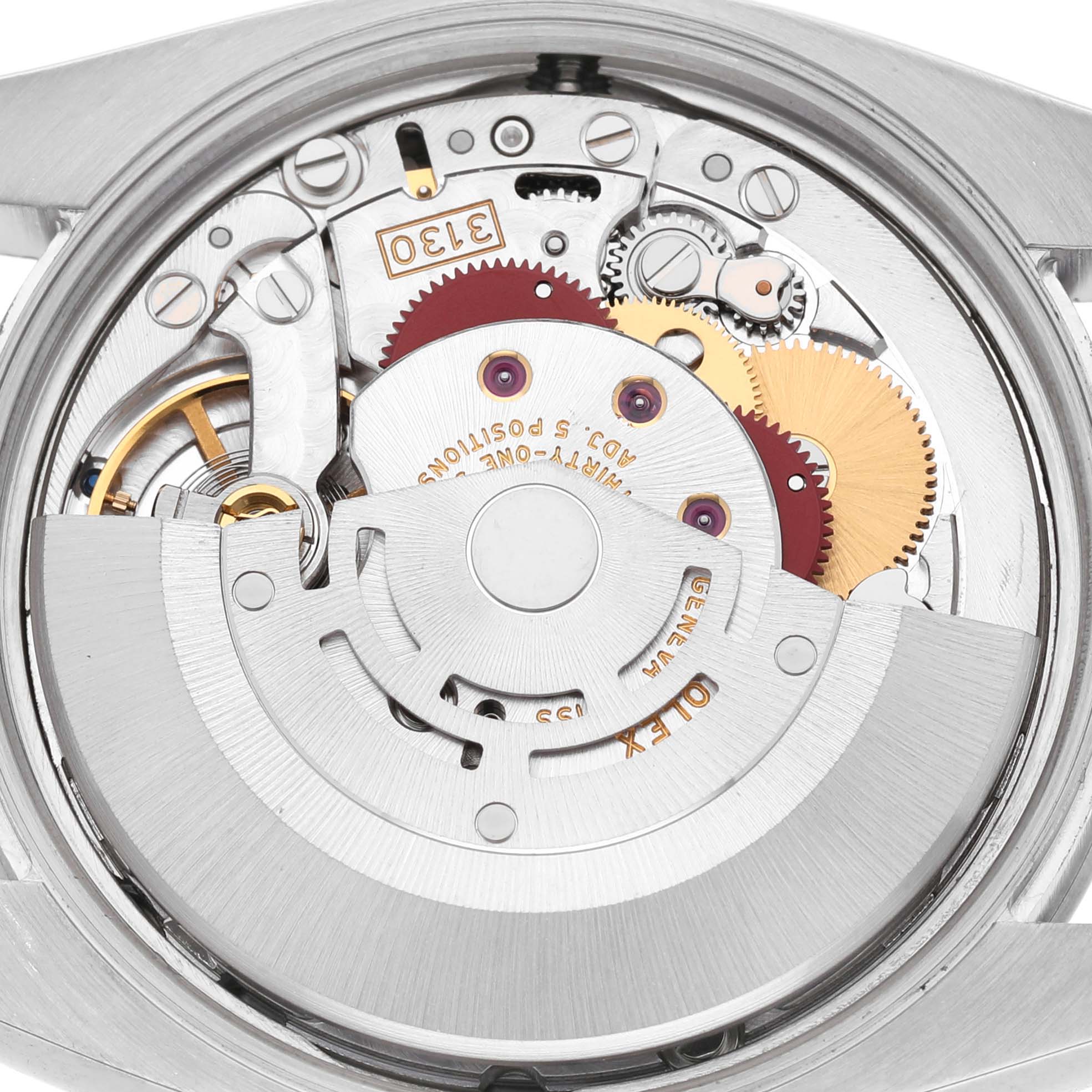 The image shows the movement of a Rolex Air-King 114200 Men's Stainless Steel Silver Dial watch from the back, highlighting gears and components.