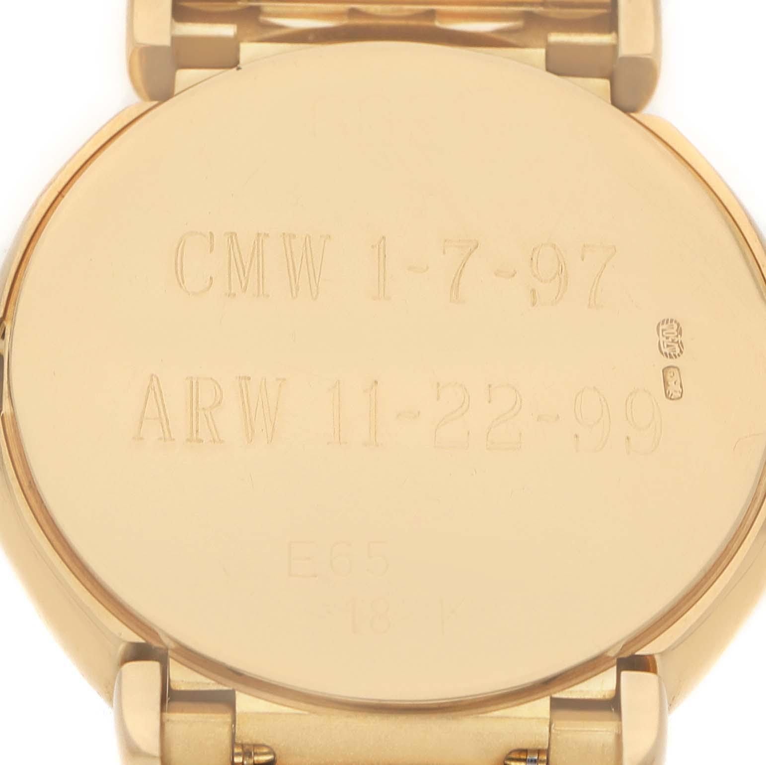 The image shows the engraved case back of a Rolex Cellini 6621 Women's Yellow Gold Champagne Dial watch, viewed from the back, with inscriptions and part of the bracelet visible.