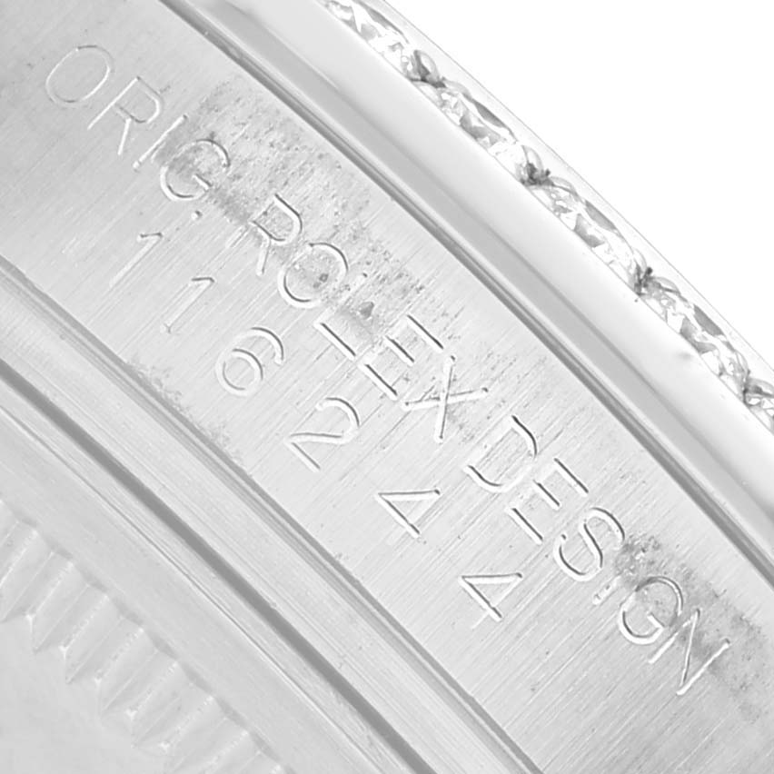 The image shows a close-up of the Rolex Datejust 116244 Men's Stainless Steel Silver Dial's inner case with engraved text, viewed from the side angle.