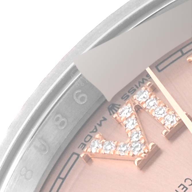 The image shows a partial close-up view of the bezel and dial of a Rolex Datejust 126231 Men's Steel and Gold (two tone) Pink Dial 126231 Men's Steel and Gold (two tone) Pink Dial watch, highlighting a diamond-encrusted Roman numeral.