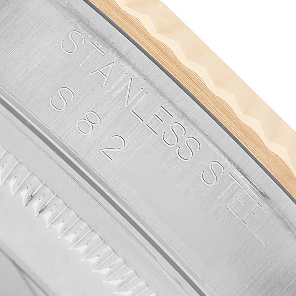The image shows a close-up of the engraved edge of a Rolex Datejust 16233 Men's Steel and Gold (two tone) White Dial watch case, highlighting the stainless steel marking.