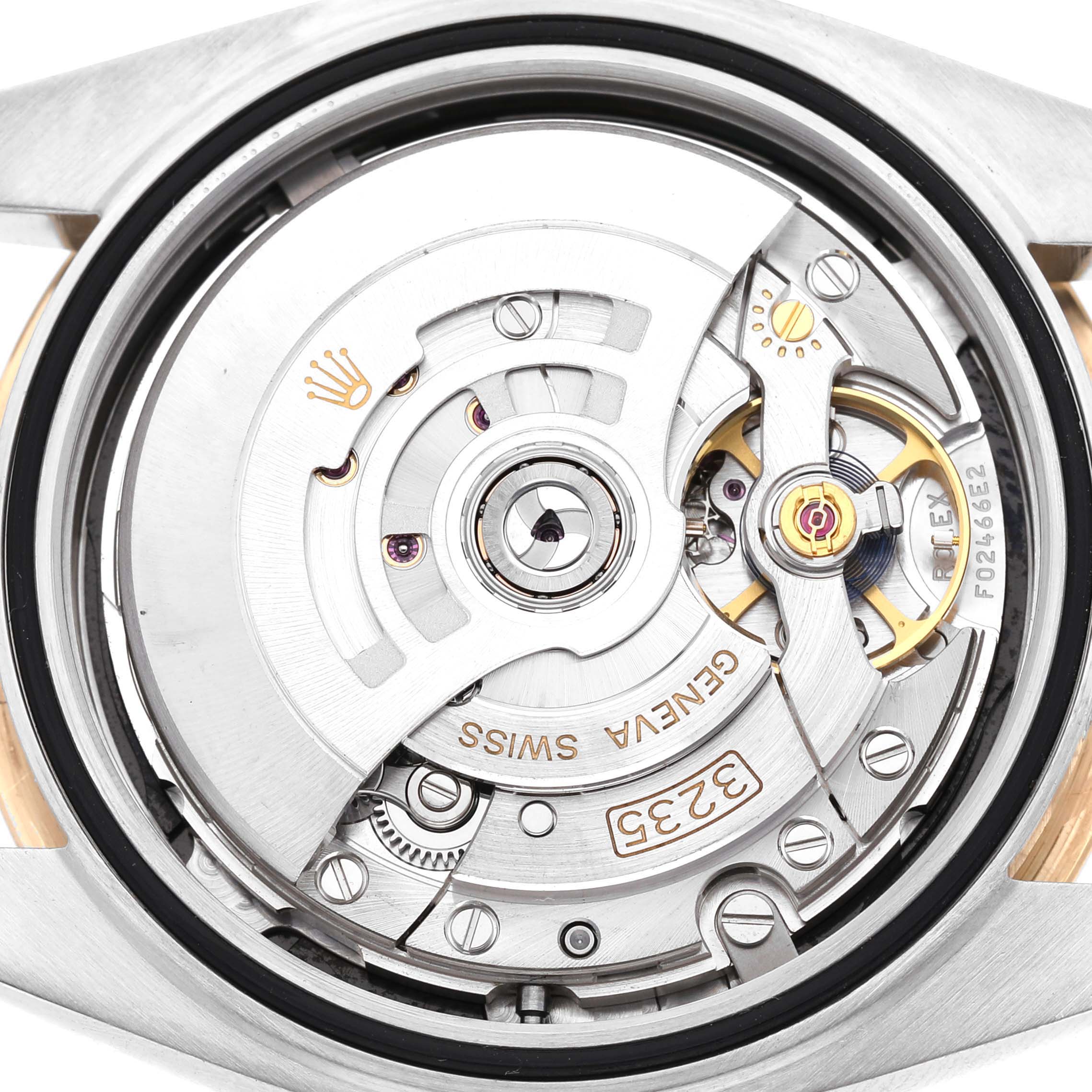 The image shows the movement of a Rolex Datejust 41 126303 Men's Steel and Gold (two tone) Black Dial from the back, highlighting the rotor and intricate mechanical parts.