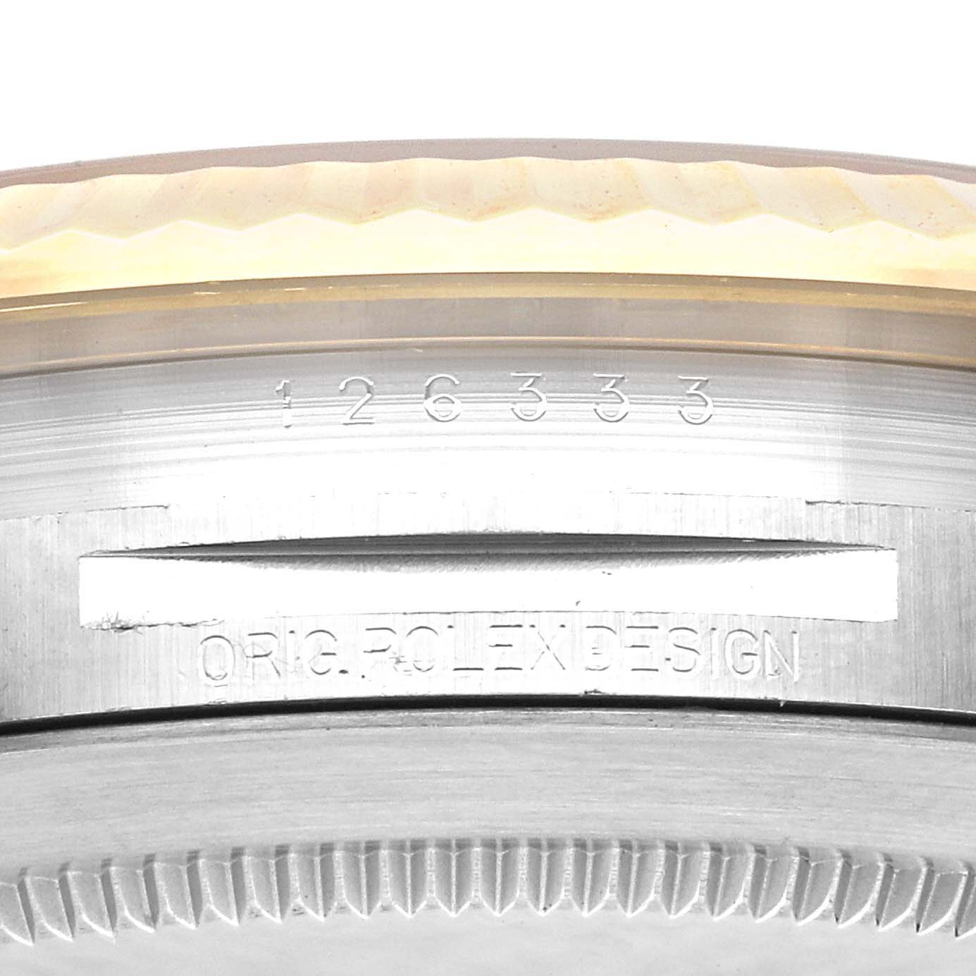 This is a close-up of a Rolex Datejust 41 126333 Men's Steel and Gold (two tone) Black Dial 126333 Men's Steel and Gold (two tone) Black Dial model showing the bezel, case edges, and engraved serial number.