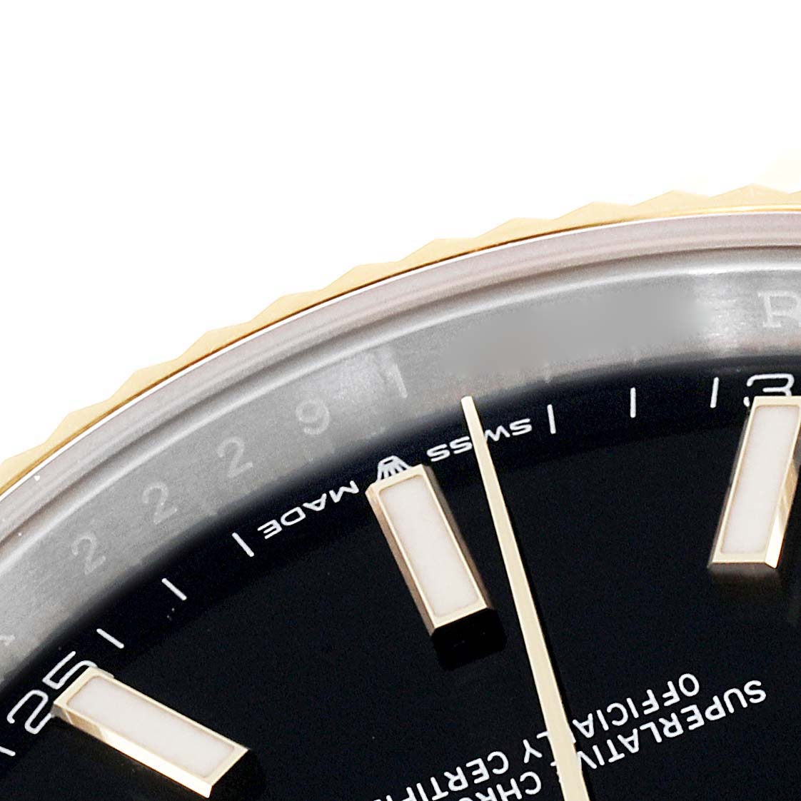 This close-up image of a Rolex Datejust 41 126333 Men's Steel and Gold (two tone) Black Dial 126333 Men's Steel and Gold (two tone) Black Dial watch features the dial, markers, and a section of the bezel.