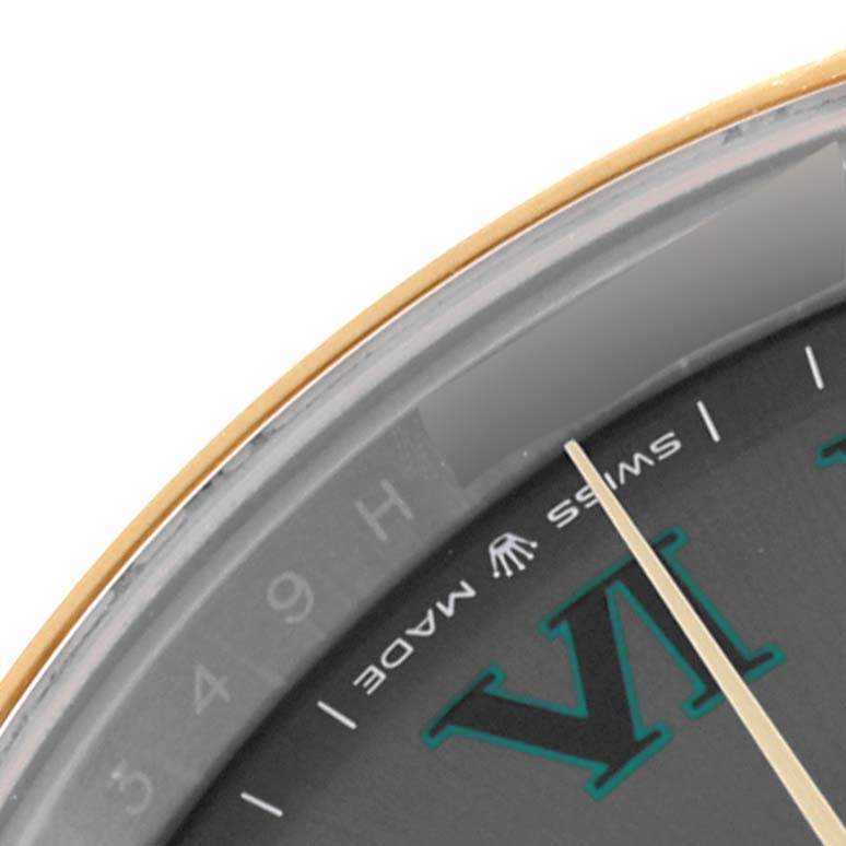 This close-up of the Rolex Datejust 41 126303 Men's Steel and Gold (two tone) Grey Dial 126303 Men's Steel and Gold (two tone) Grey Dial watch shows a portion of the dial with the "VI" hour marker and the "Swiss Made" text.