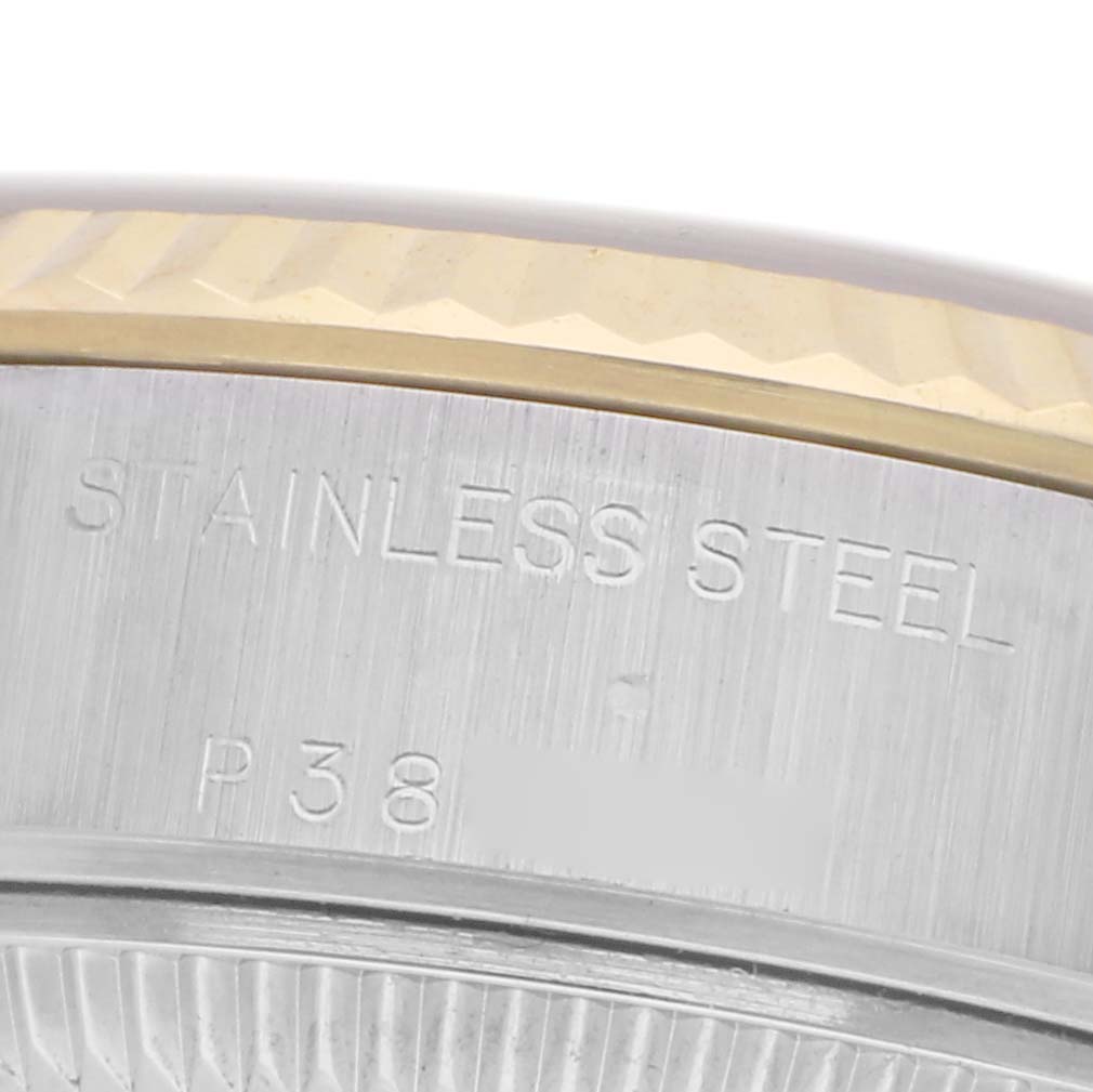 The image shows a close-up of the side of a Rolex Datejust 79173 Women's Steel and Gold (two tone) Champagne Dial 79173 Women's Steel and Gold (two tone) Champagne Dial watch, highlighting the stainless steel bezel and engraved markings.
