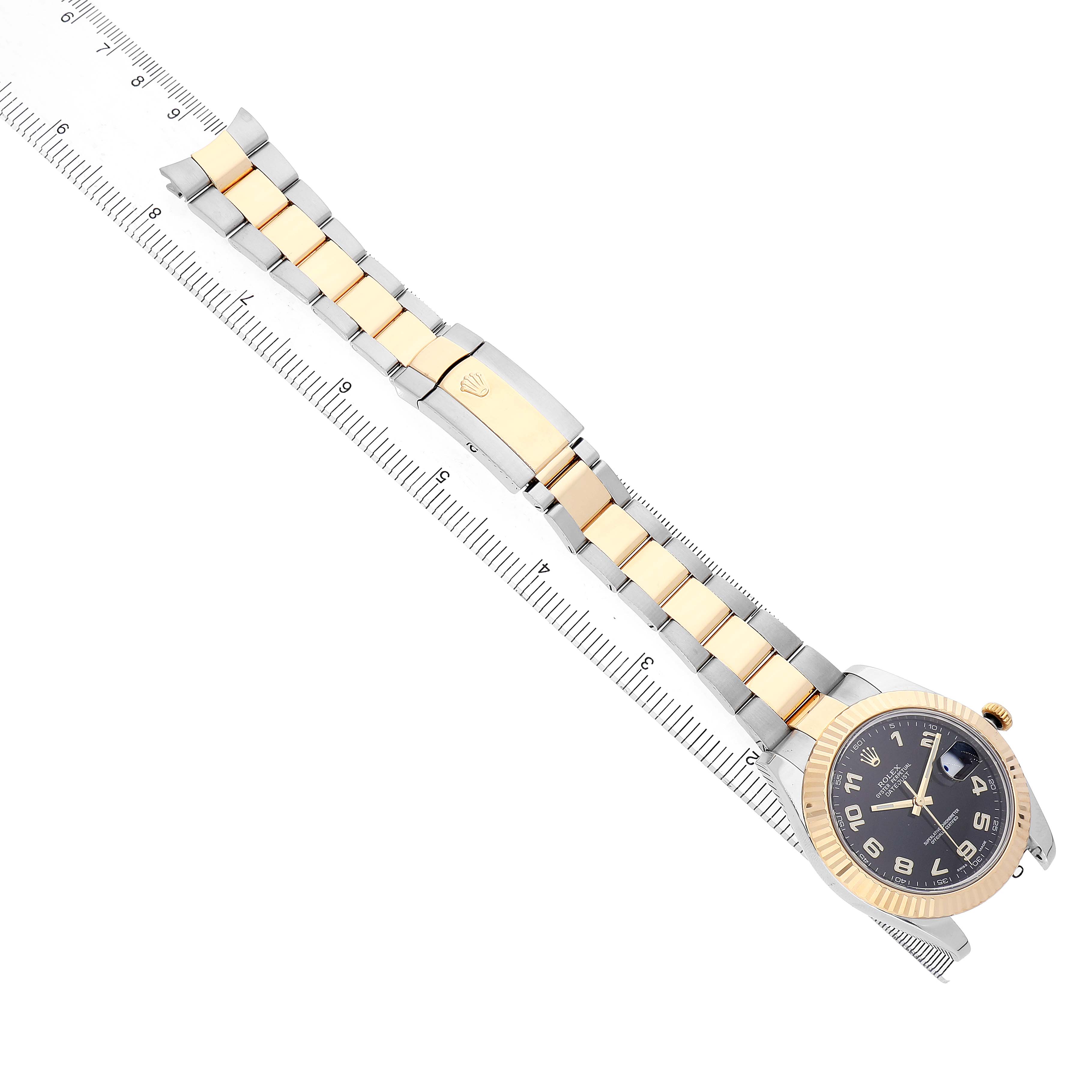 The Rolex Datejust 41 116333 Men's Steel and Gold (two tone) Black Dial is shown at an angled top view, displaying the bracelet and dial alongside a measuring ruler.