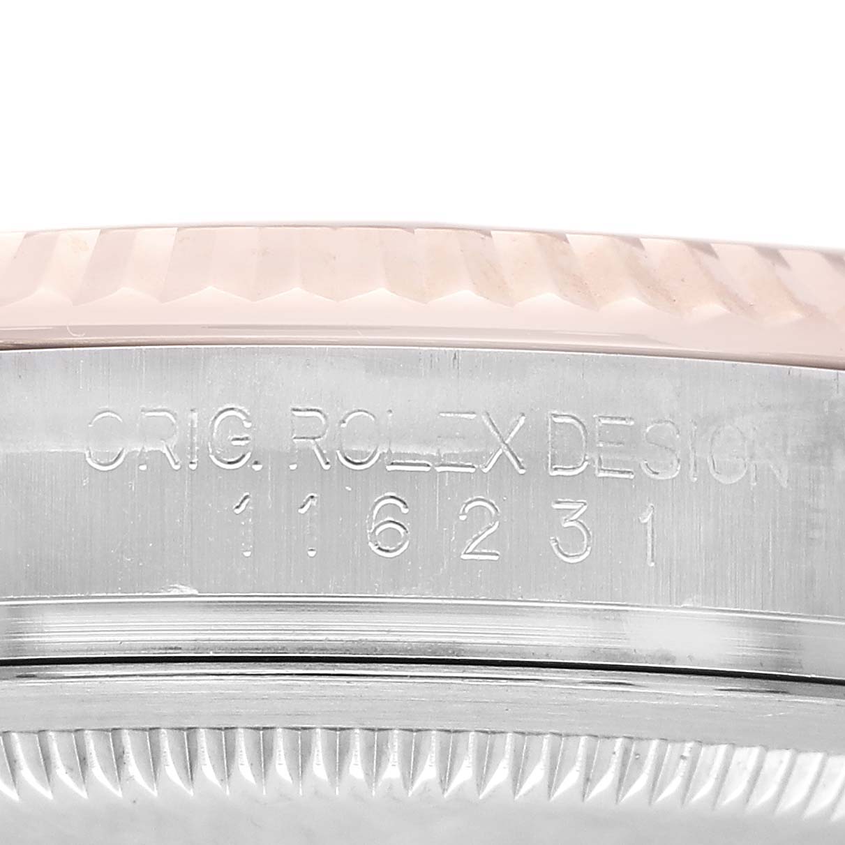 The image shows a side view of the Rolex Datejust 116231 Men's Steel and Gold (two tone) Black Dial case with engraved text and the edge of the fluted bezel.