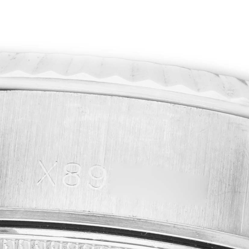 The image shows a close-up of the side of a Rolex Datejust 69174 Women's Stainless Steel Silver Dial, focusing on the bezel and engraved serial numbers.