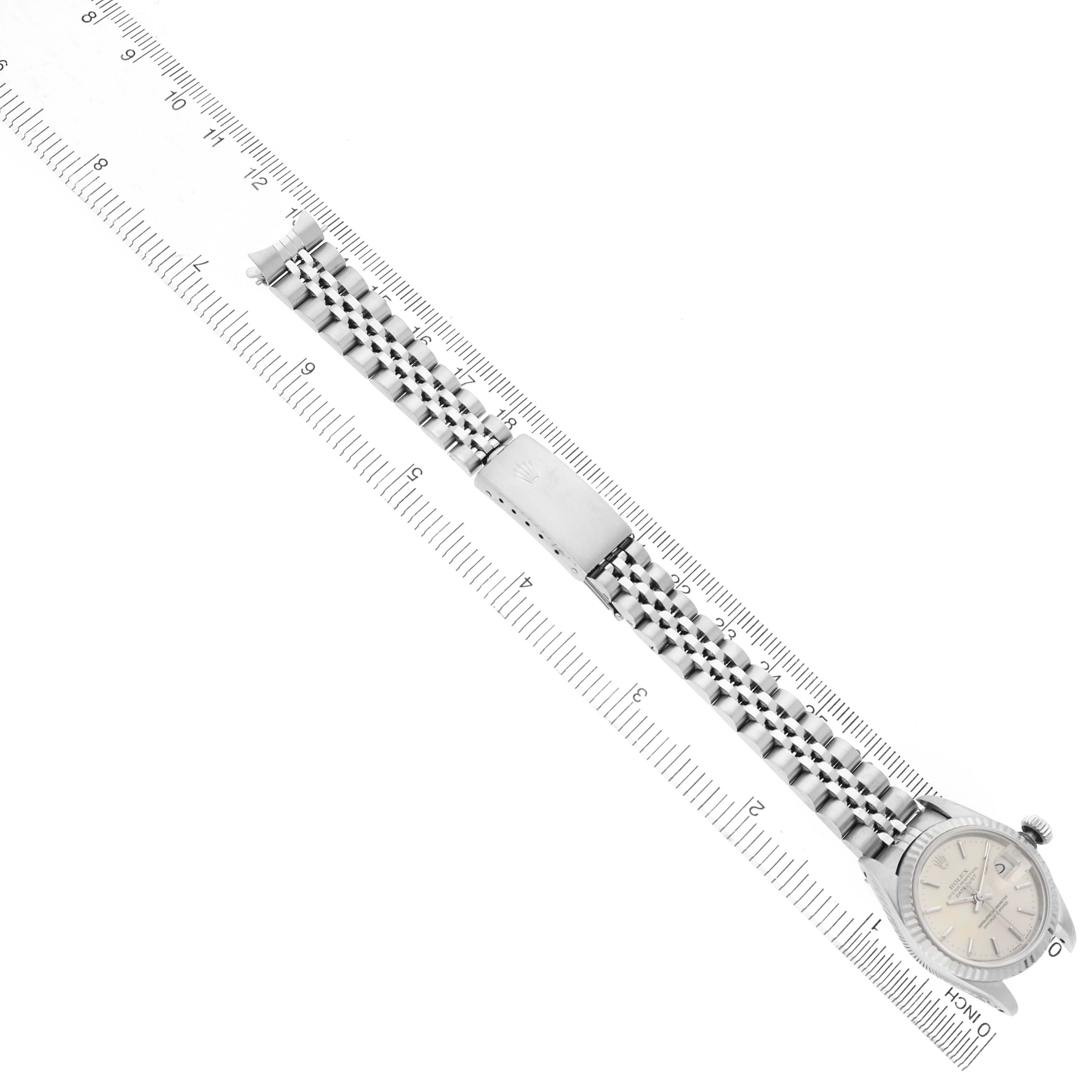 The image shows a Rolex Datejust 69174 Women's Stainless Steel Silver Dial watch laid flat with its bracelet and clasp visible, placed next to a ruler.