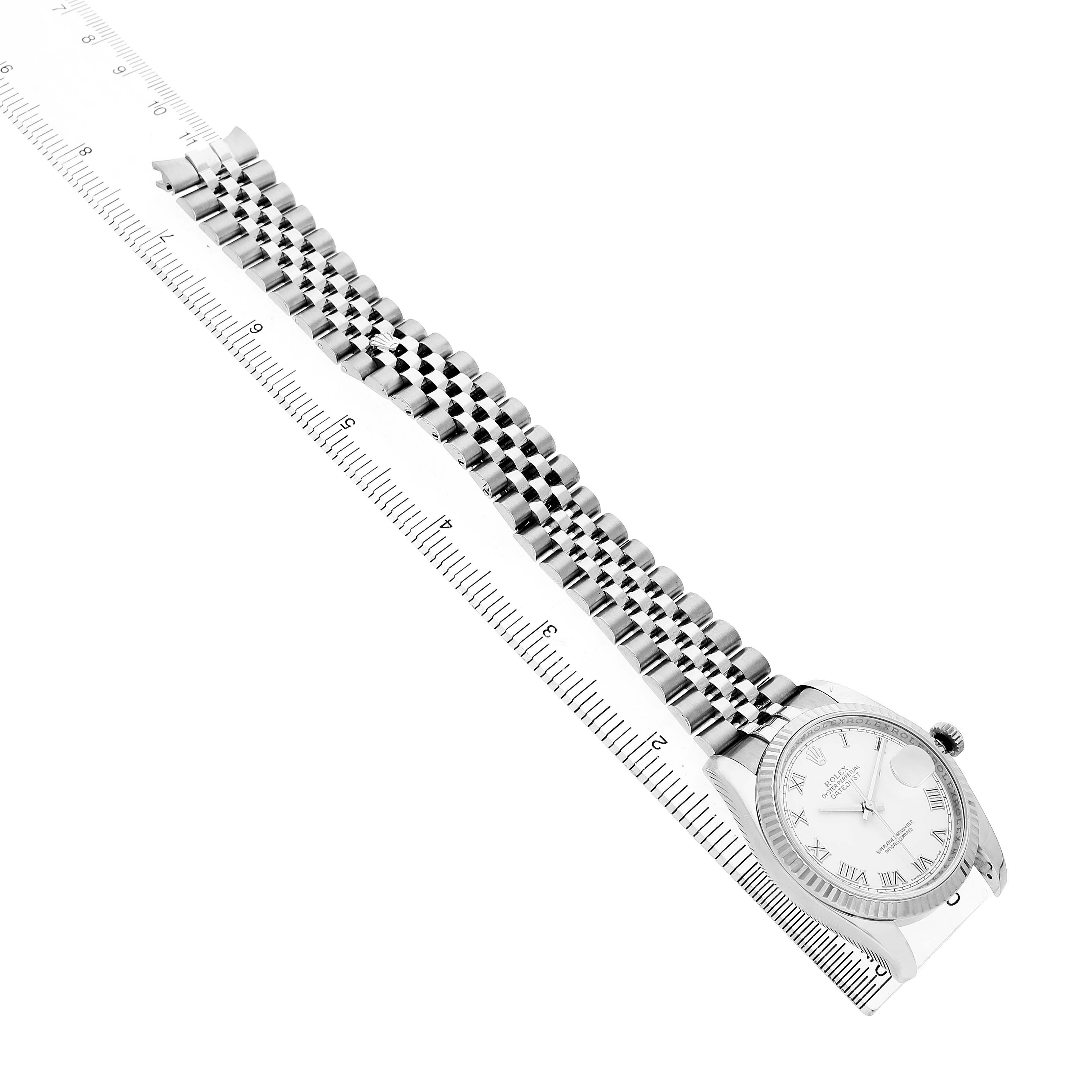 The image shows a Rolex Datejust 116234 Men's Stainless Steel White Dial watch at an angled side view, highlighting the dial, case, and bracelet aligned with a ruler.